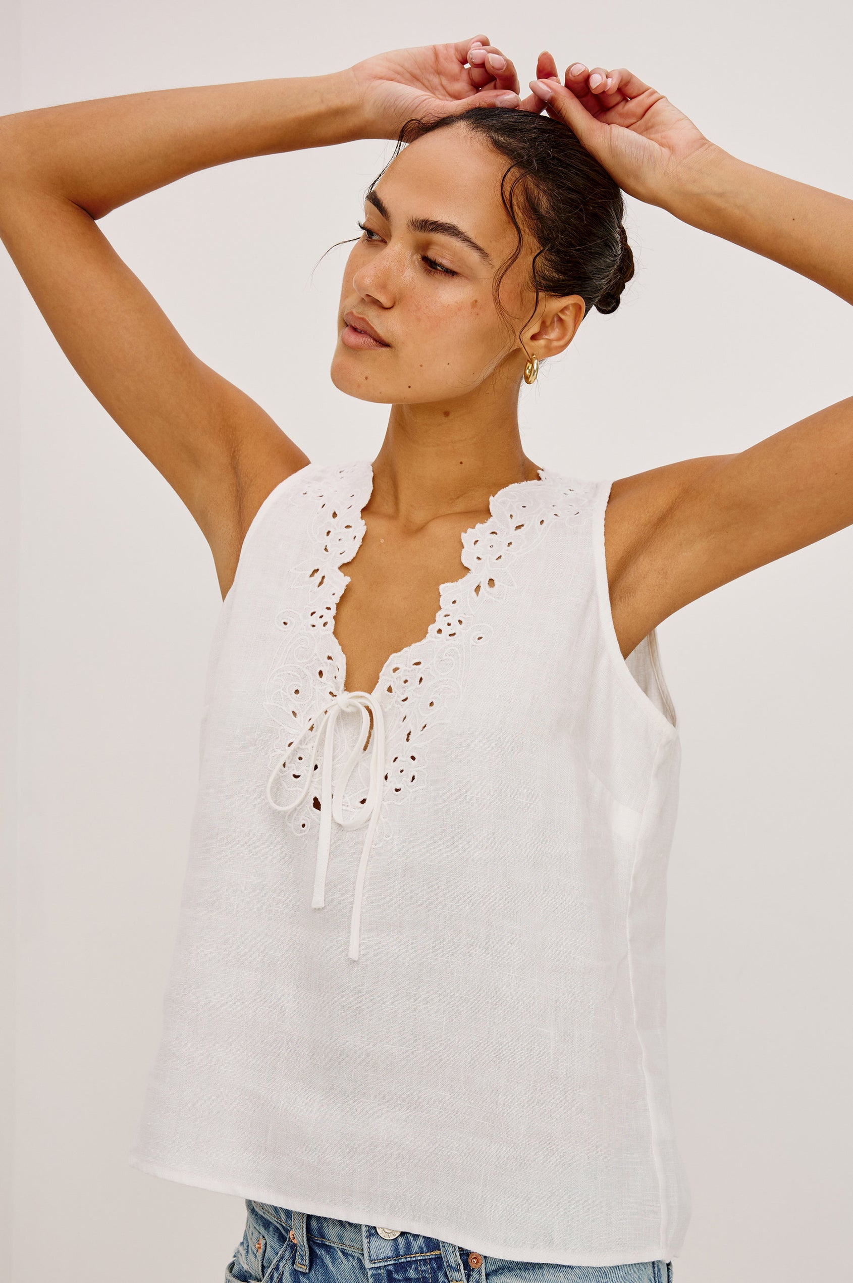 Cornelia Sleeveless Top in Heavy Linen With Embroidered Deep V-Neckline and Keyhole Self-Ties in White Colorway - Upper Body Front View Featured on Model