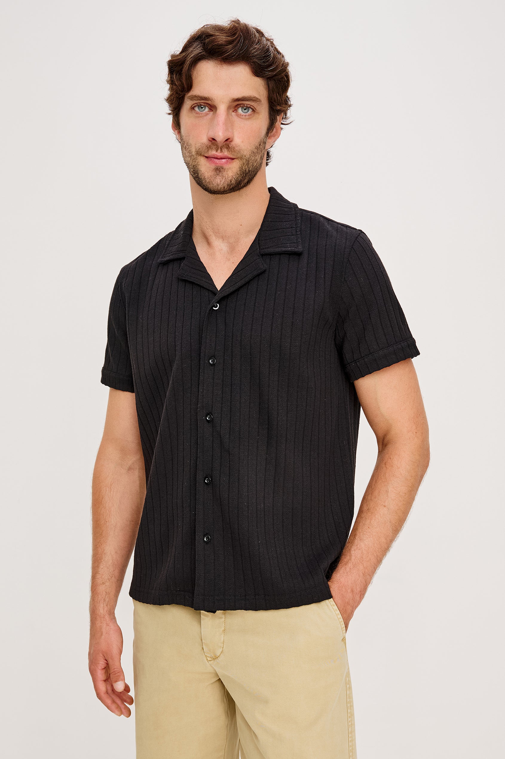Corrin is a short sleeve camp style shirt with a notched lapel in Black colorway. Front view featured on model.
