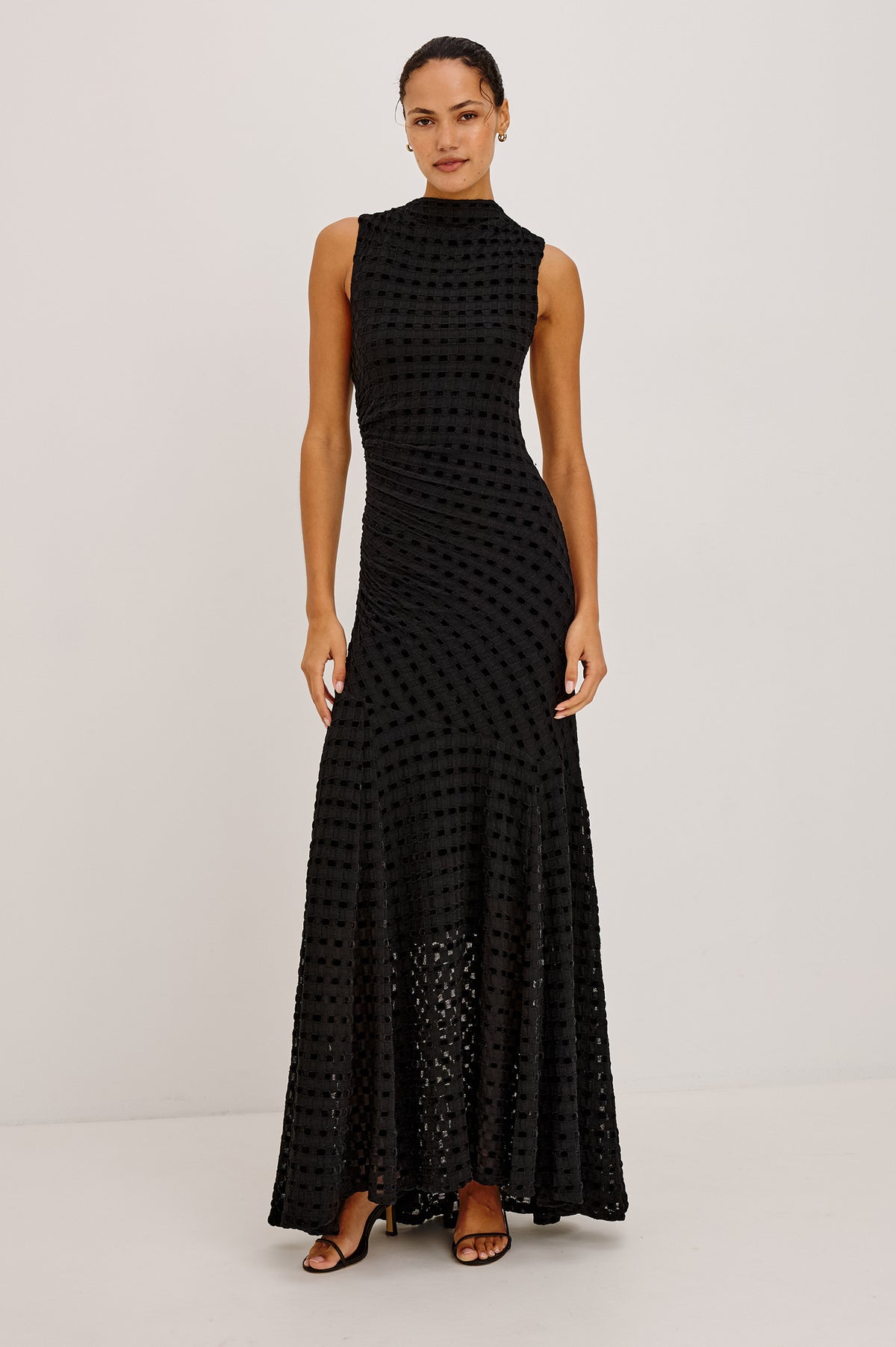 Cosmos Dress in Checkerboard Devoré With Mock Neck, Sleeveless Silhouette, and Ruched Waist in Black Checkerboard Colorway - Full Body Front View Featured on Model.