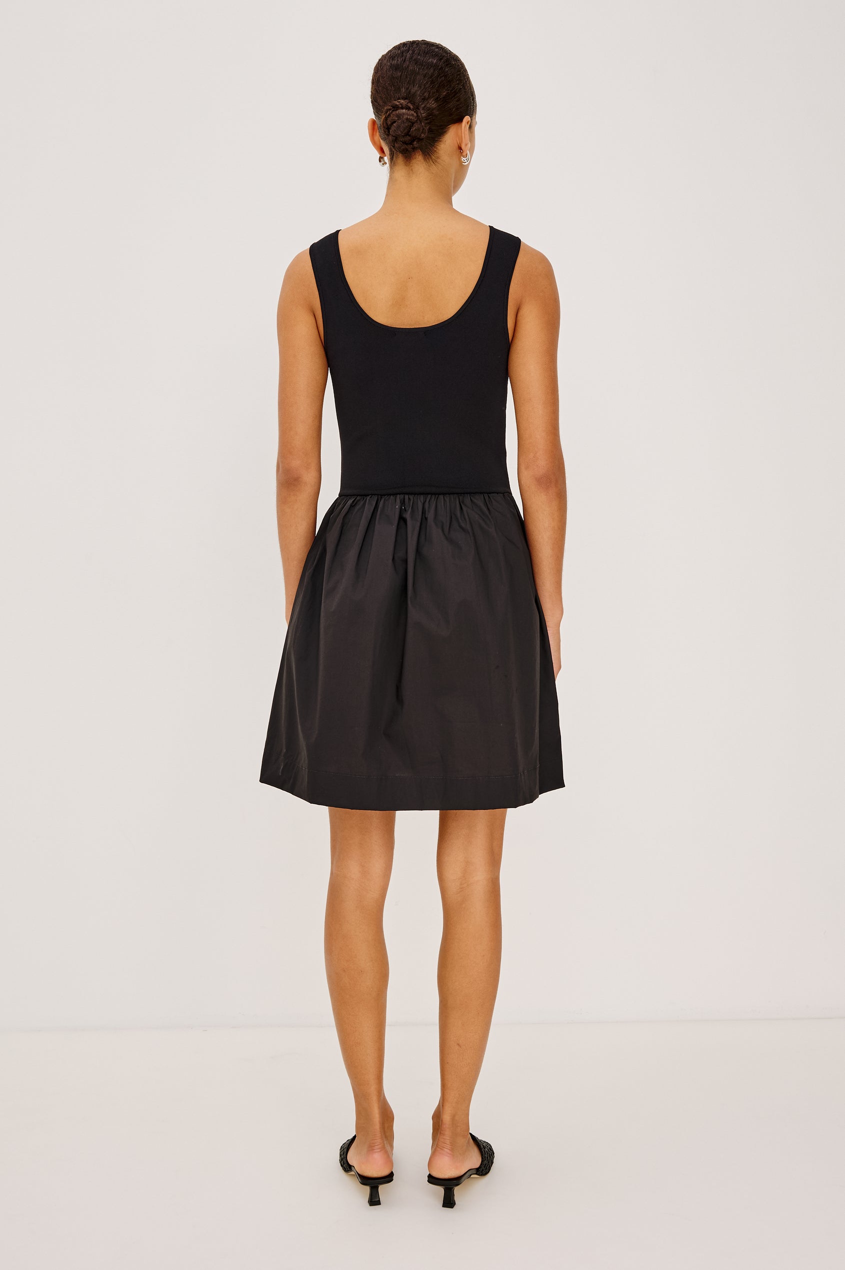 Courtney Mini Dress With Soft Jersey Bodice and Dropwaist Cotton Poplin Skirt, Tank Straps, Scoop Neckline, and Side Pockets in Black Colorway - Full Body Back View Featured on Model