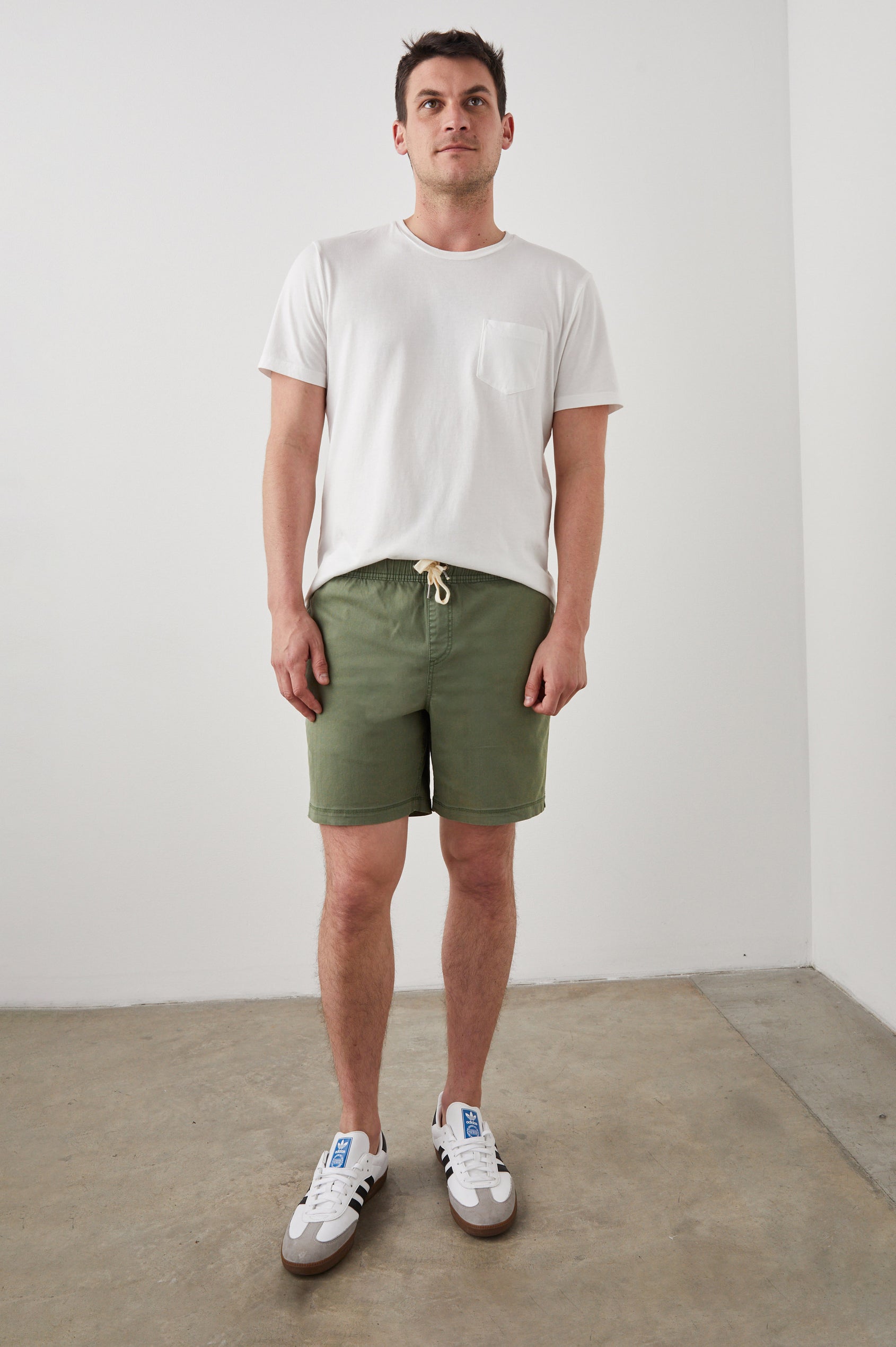 Cruz Short in Vintage-Washed Cotton With Drawstring Ties, Side Pockets, and Back Button Patch Pockets in Spring Olive Colorway - Full Body Front View Featured on Model