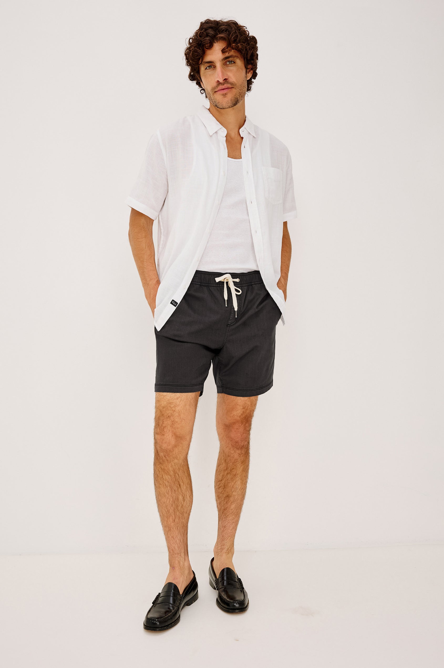 Cruz Short in Stretch Cotton With Drawstring Waist TIes, Side Pockets, and Relaxed Fit in Washed Black Colorway - Full Body Front View Featured on Model