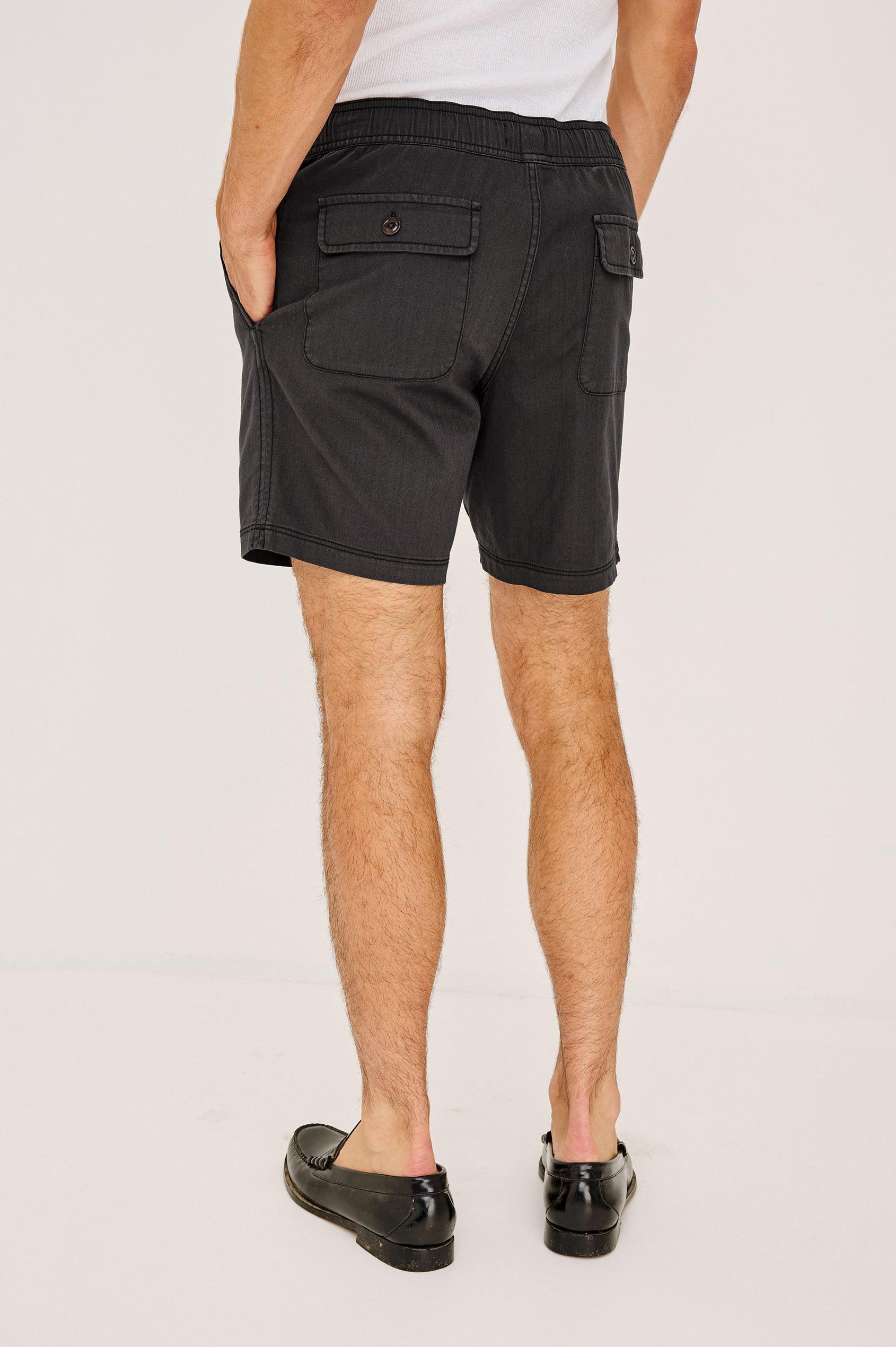 Cruz Short in Stretch Cotton With Drawstring Waist TIes, Side Pockets, and Relaxed Fit in Washed Black Colorway - Lower Body Back View Featured on Model