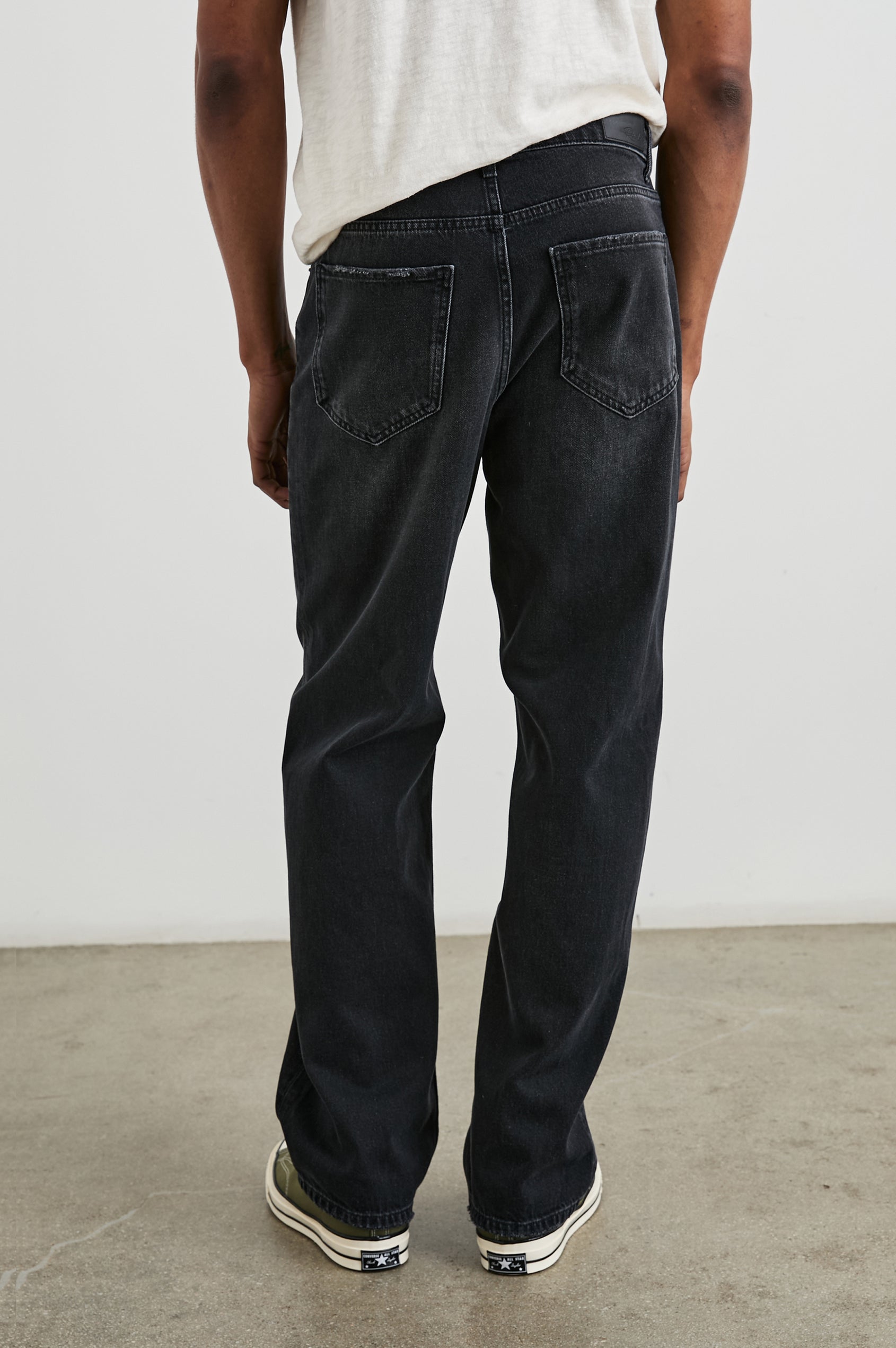 Cutler 90's Loose Jeans with Belt Loops, Two Front Pockets plus a Coin Pocket and Two Back Patch Pockets in Distressed Black Colorway - Back View Featured on Model