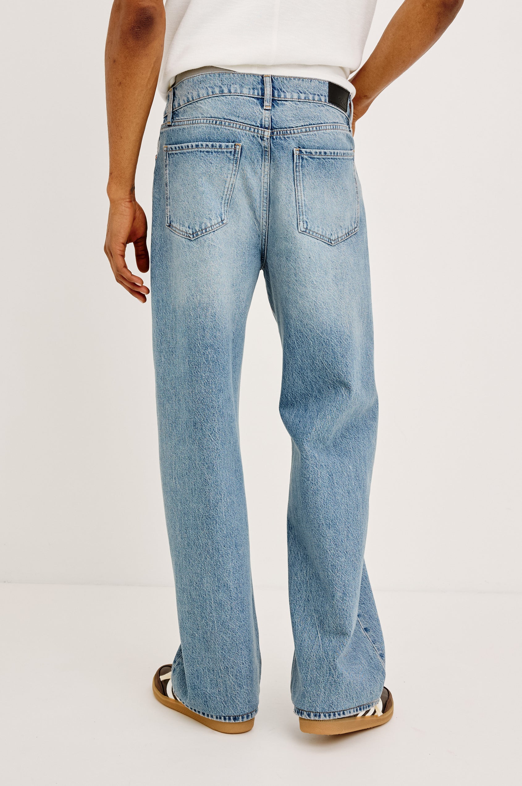 Cutler '90s Loose Jean in Rigid Denim With Loose Legs, Light Distressing, Front Zip Fly, and 5-Pockets in Medium Vintage Wash Colorway - Lower Body Back View Featured on Model
