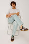 Cutler 90's Loose Jeans with Belt Loops, Two Front Pockets plus a Coin Pocket and Two Back Patch Pockets in Vintage Light Wash Colorway - Front Seated View, Featured on Model