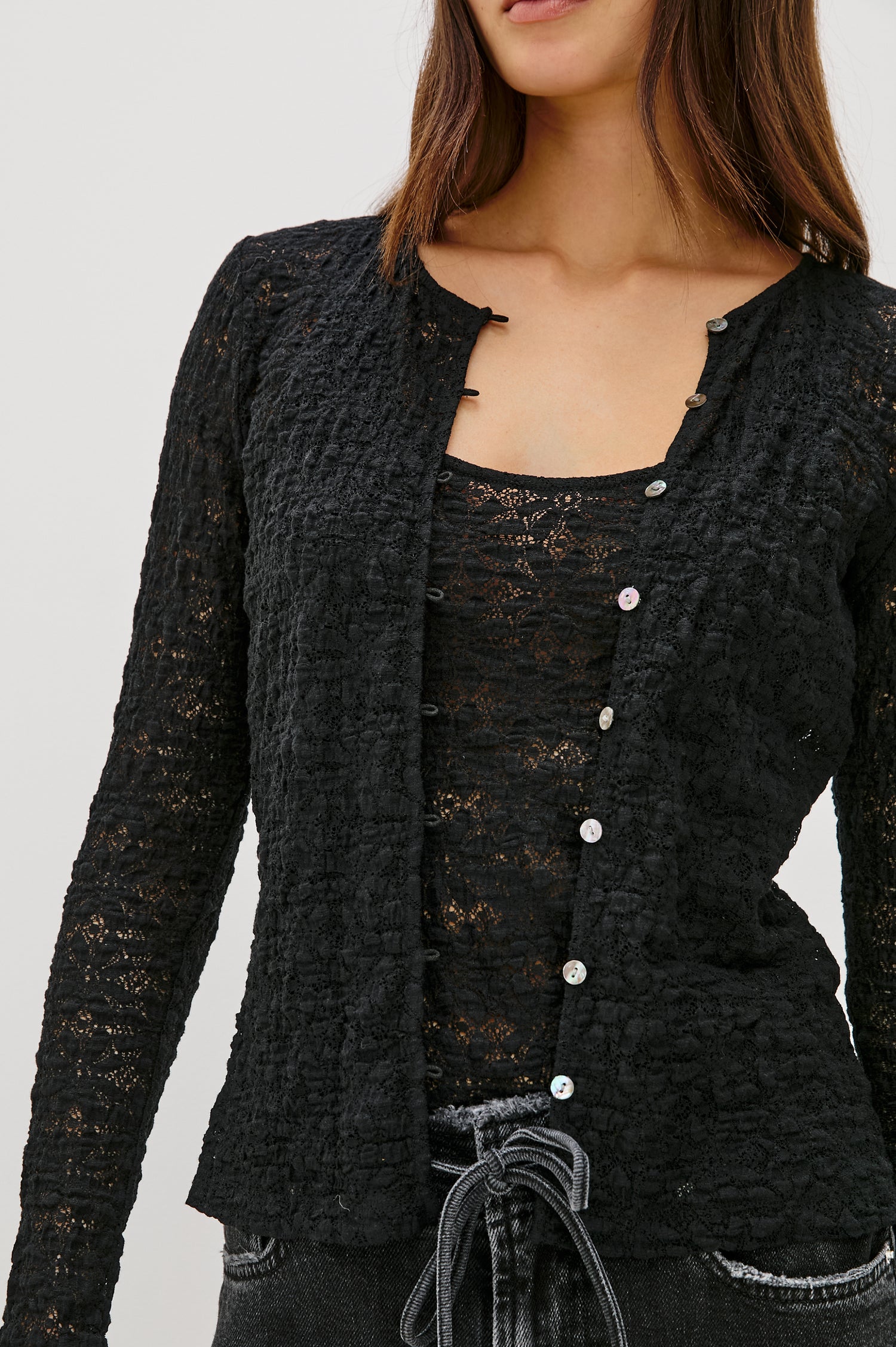 Cyrah long-sleeve top in Black Lace with a button-front closure - front view featured on model.