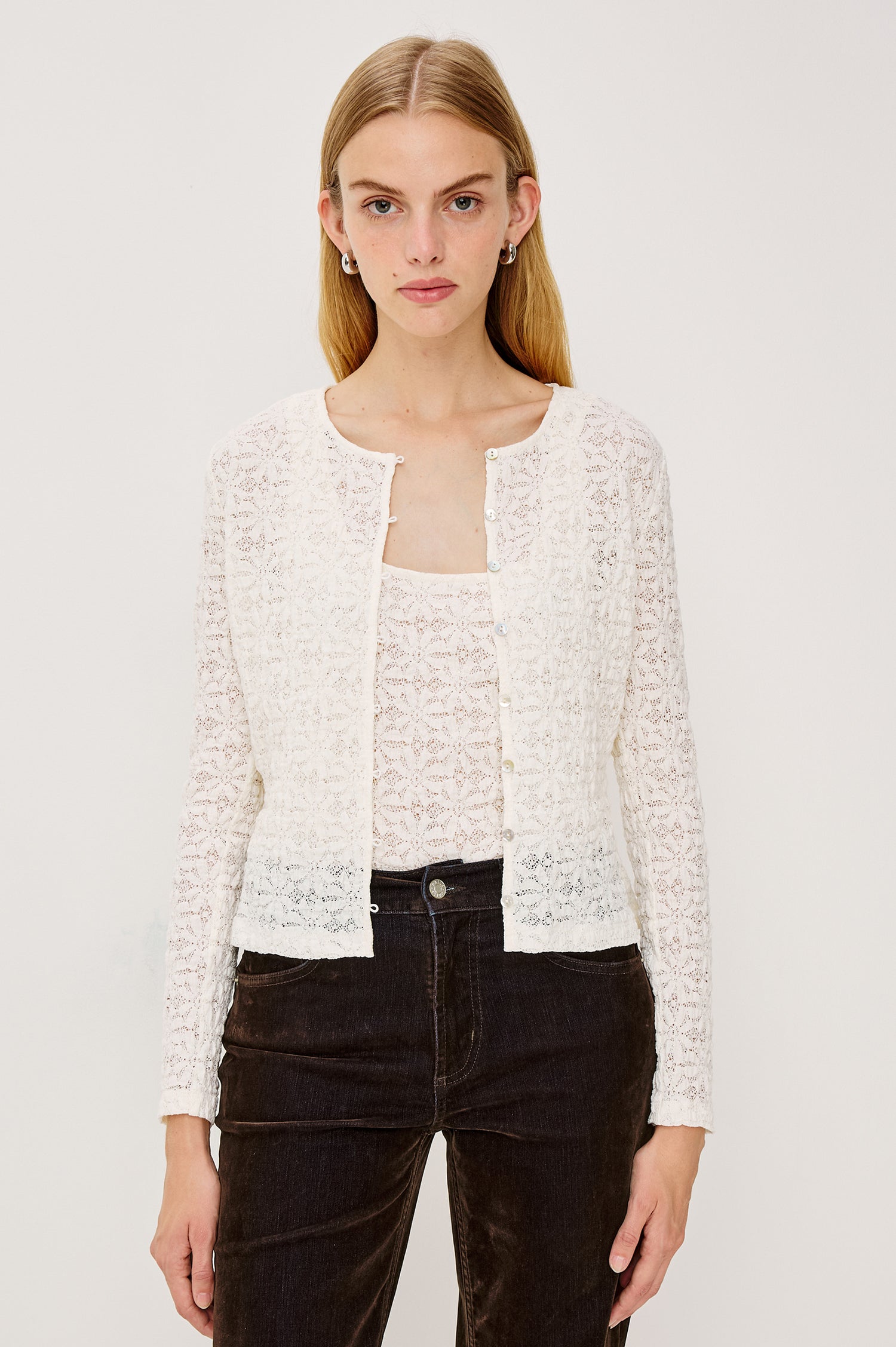 Cyrah Cardigan in Sheer Stretch Lace With Fitted Long Sleeves, and Front Button-and-Loop Closures in Ivory Colorway - Upper Body Front View Featured on Model