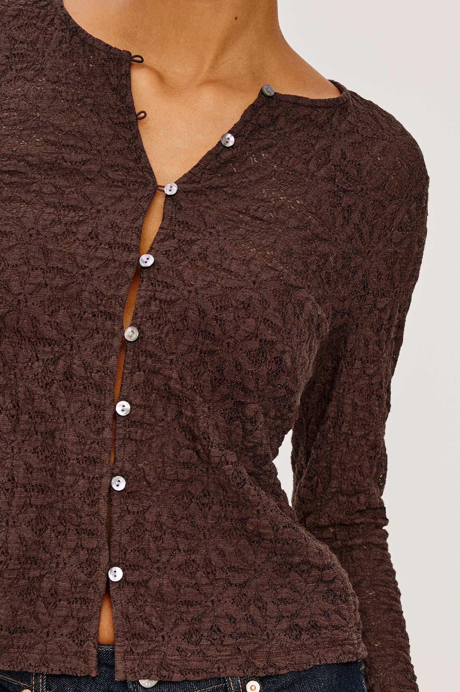 Cyrah Cardigan in Sheer Stretch Lace With Fitted Long Sleeves, and Front Button-and-Loop Closures in Walnut Colorway - Upper Body Close Up View Featured on Model