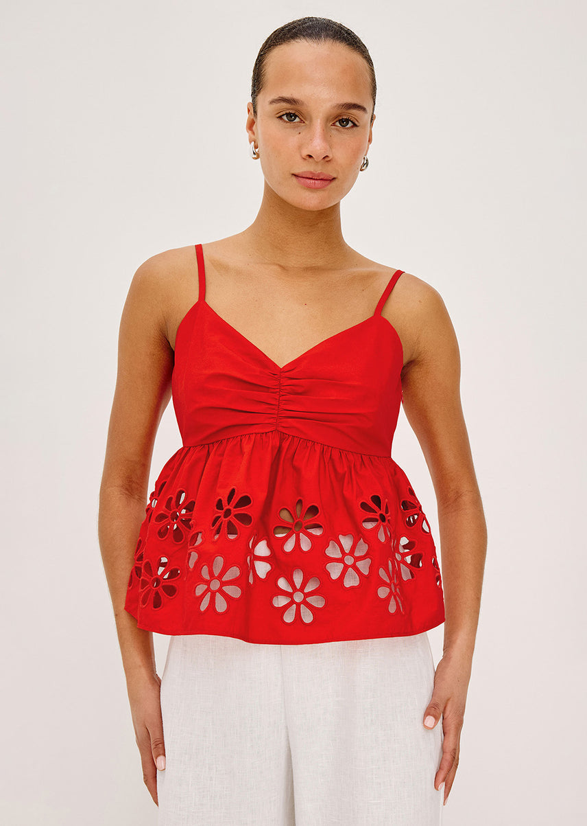 Woman in a red top with flower detailing on the bottom