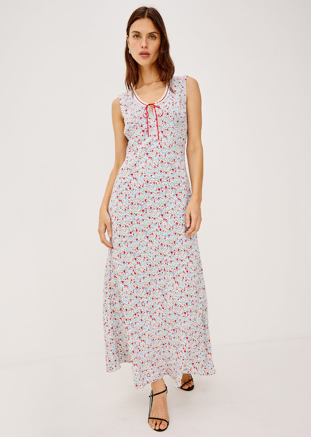 Woman wearing a floral dress on a white background