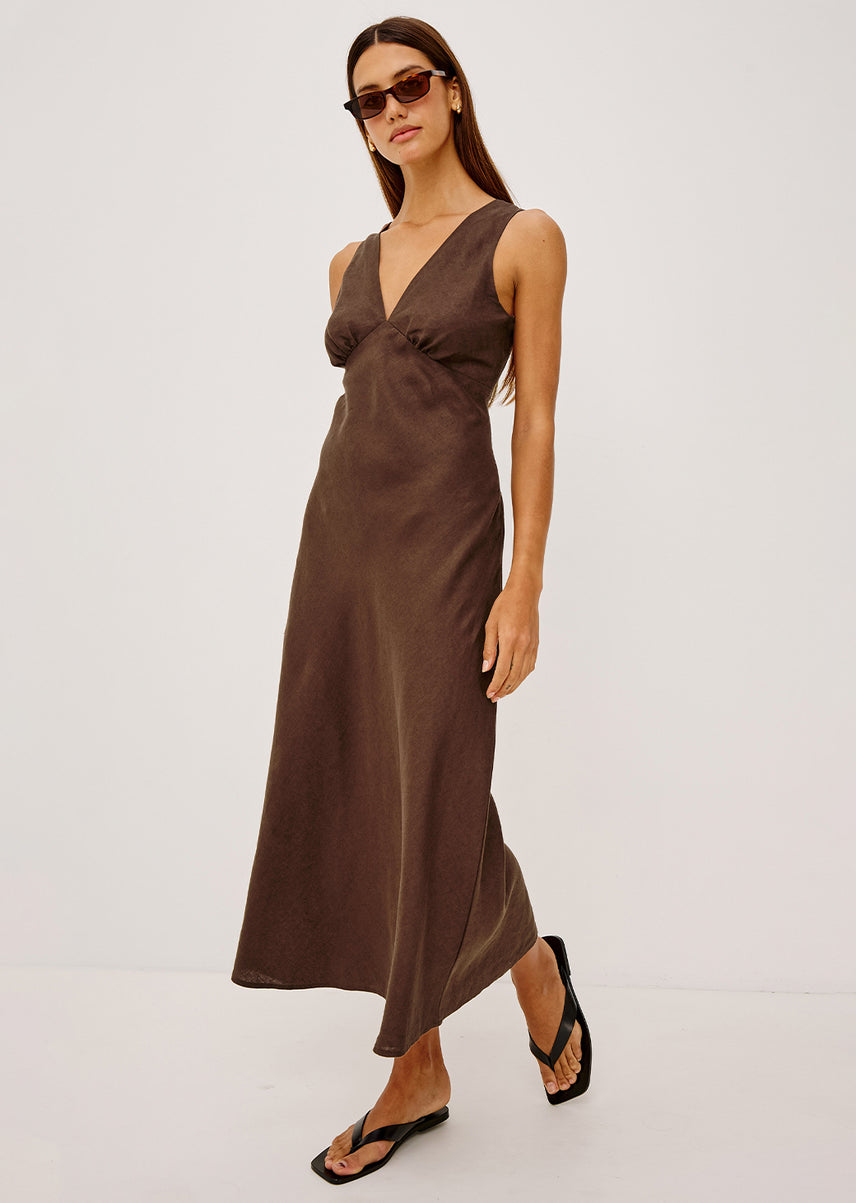 Woman wearing a brown dress on a white background