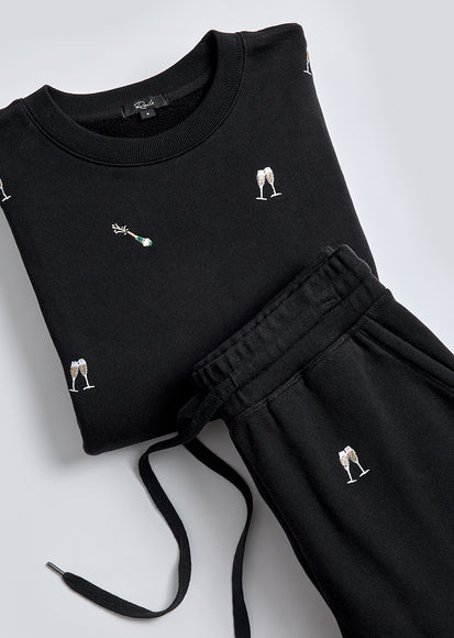 IMAGE OF VARSITY SWEATSHIRT AND KINGSTON PANT IN BLACK CHAMPAGNE EMBROIDERY FOLDED TOGETHER