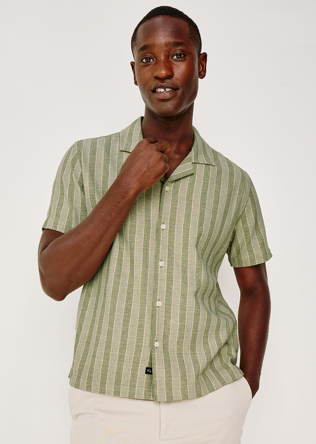 Man wearing a green striped shirt against a white background