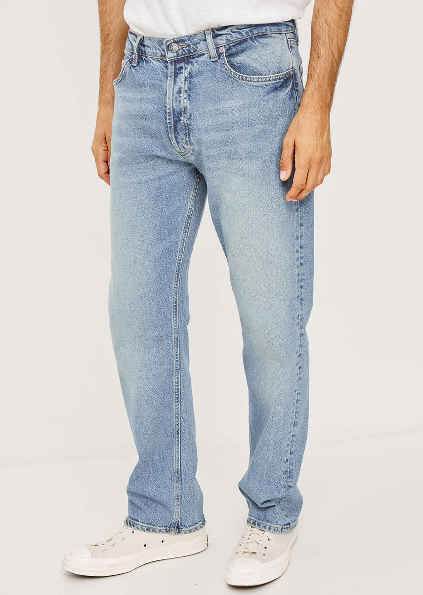 Light blue jeans worn by a person on a white background
