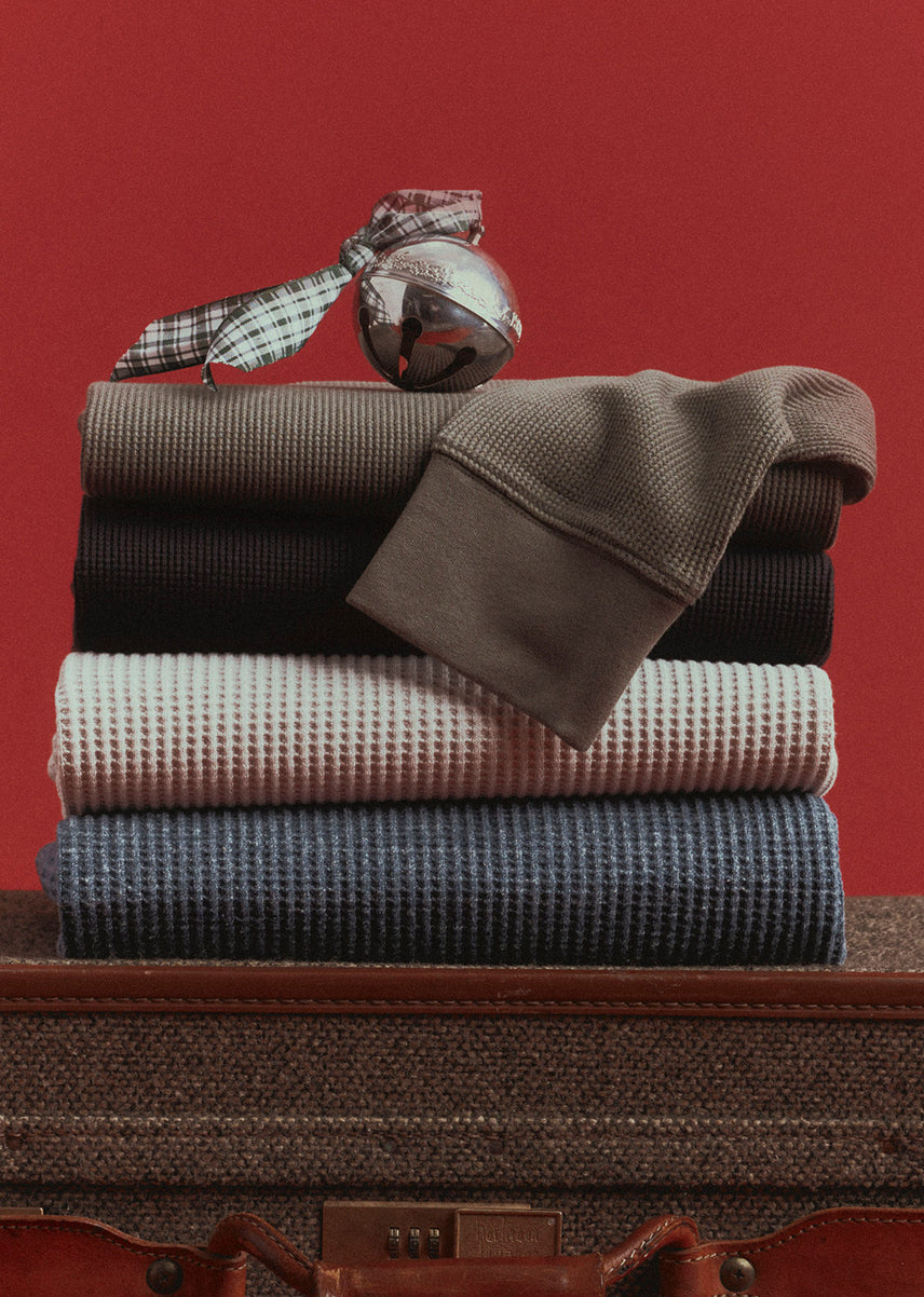 Stack of different colored waffle thermals nicely positioned against a red background.