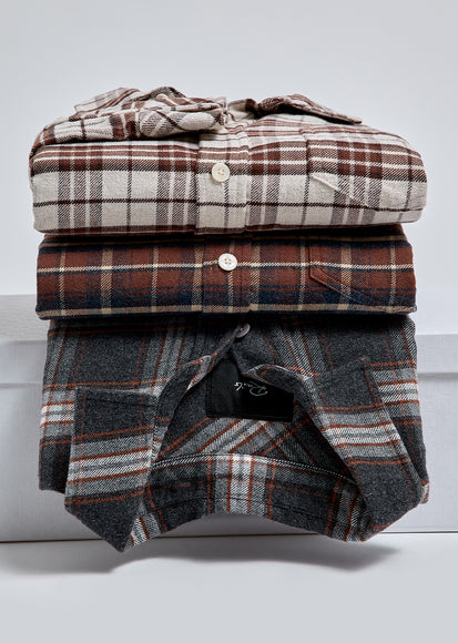MULTIPLE PLAID SHIRTS FOLDED ON TOP OF EACH OTHER
