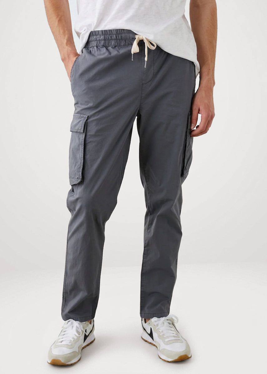 Man wearing charcoal grey cargo pants against a white background.