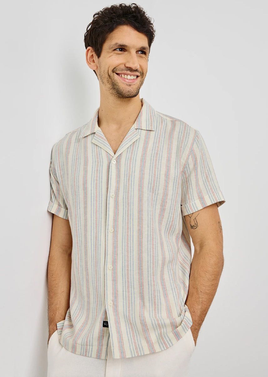 Man wearing a striped shirt against a plain background