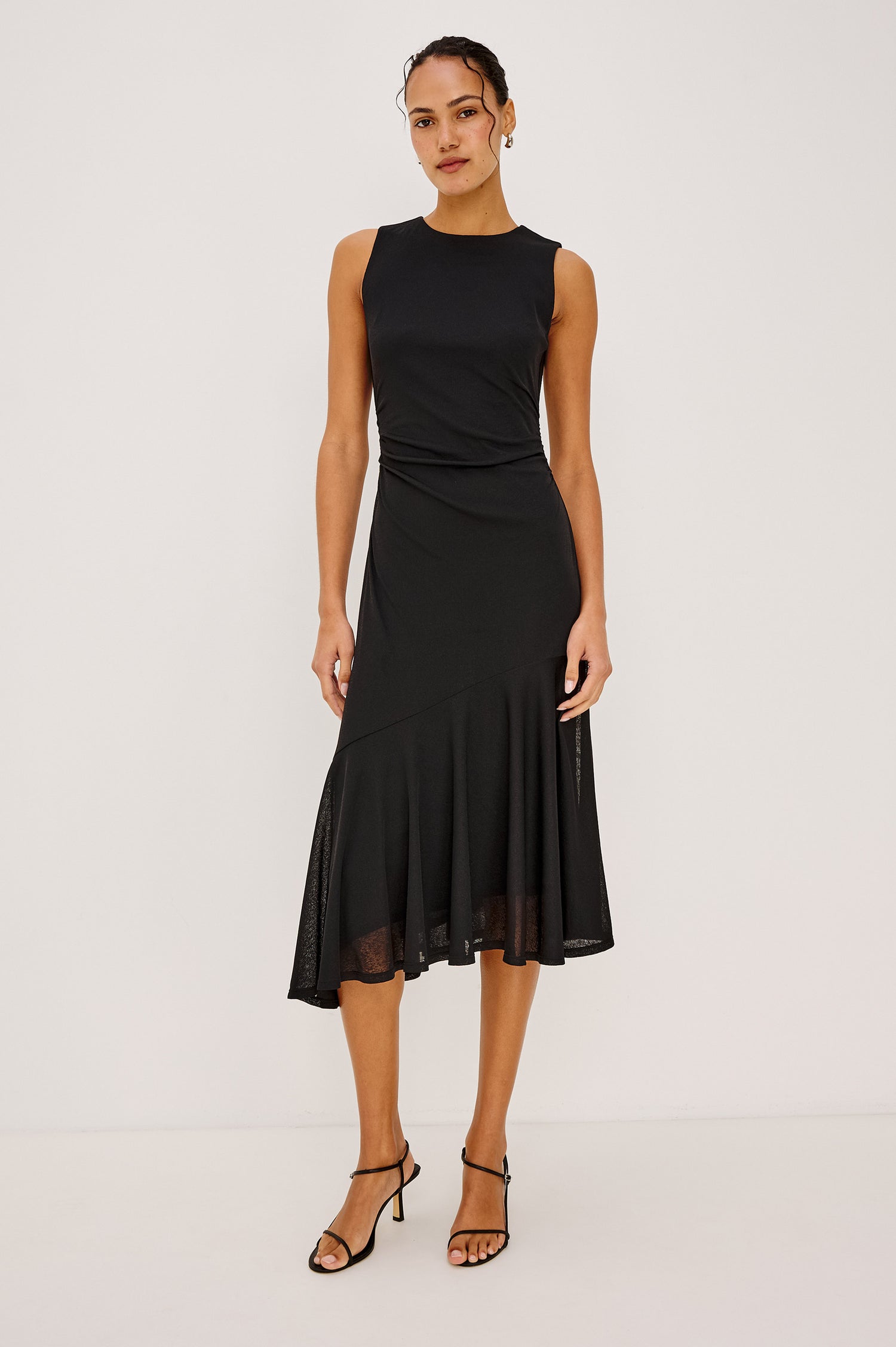 Daija Midi Dress in Compact Mesh With High Neckline, Gathered Waist, and Asymmetrical A-Line Skirt in Black Colorway - Lower Body Front Close Up View Featured on Model