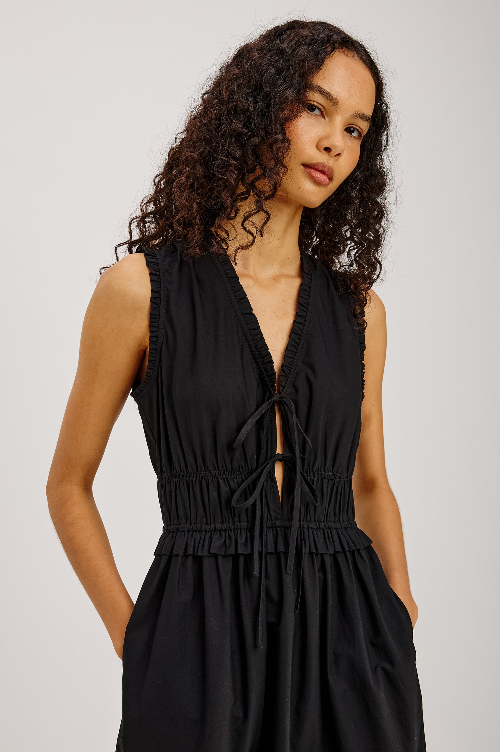 Dana Midi Dress in Cotton Poplin With Deep V-Neck and Center-Front Ties, Laddered Elastic Waist, Fully Lined Tiered Skirt, On-Seam Side Pockets, and Ruffle Trim in Black Colorway - Upper Body Front View Featured on Model