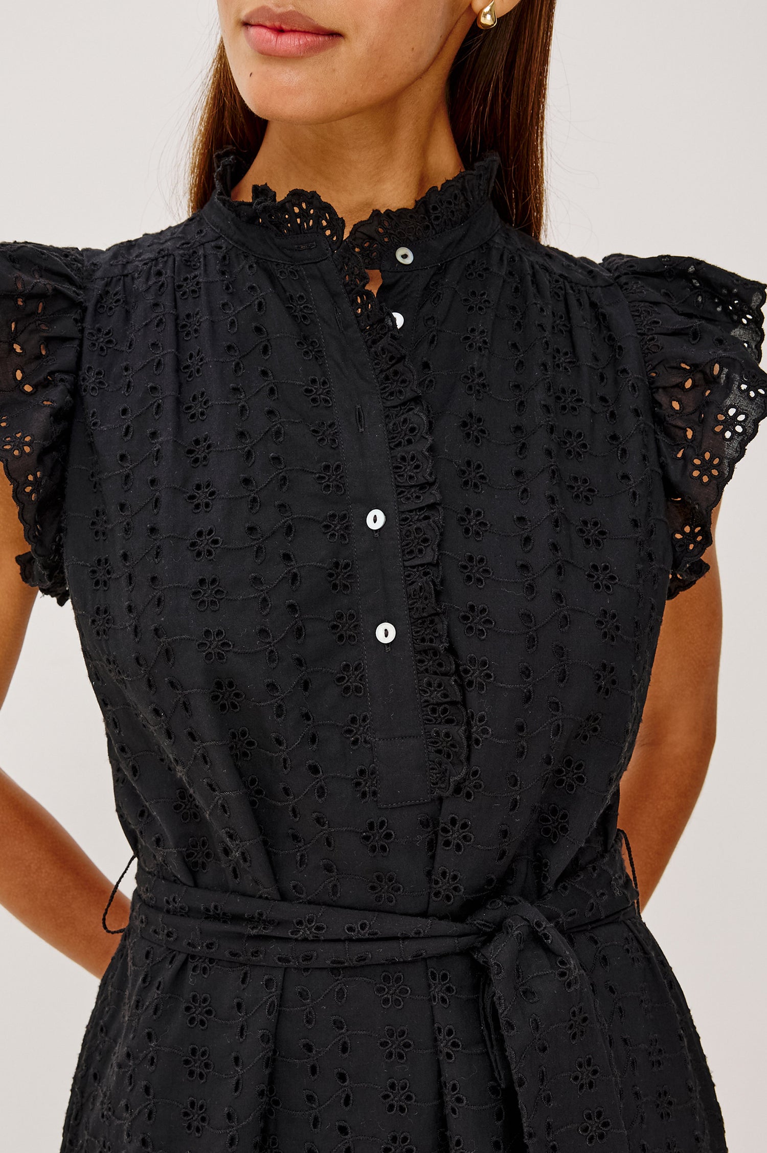 Darcy Midi Dress in Cotton Voile With Ruffled Collarless Neckline, Half-Placket, Eyelet Cutwork, Short Flutter Sleeves, Wide Self-Tie Belt, and Lined Skirt in Black Eyelet Colorway - Upper Body Front View Featured on Model