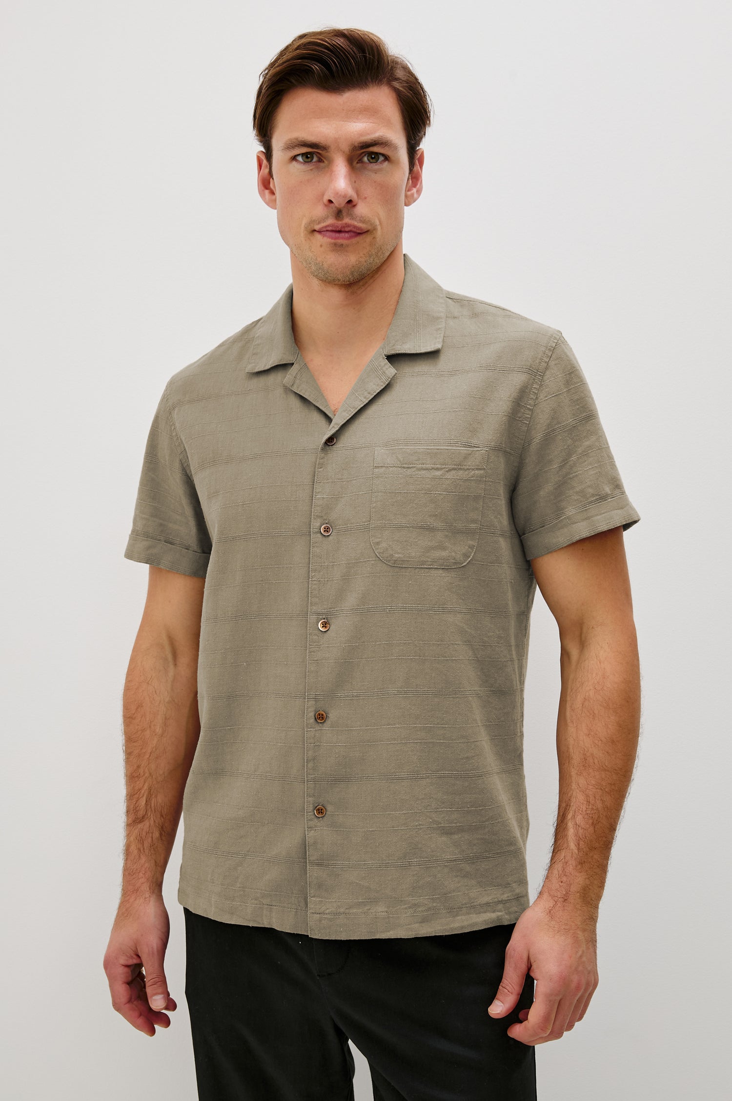 Davis Short Sleeve Button Up with a Chest Patch Pocket, Rolled Cuffs and Textured Horizontal Stripes in Crater Colorway - Front View Featured on Model