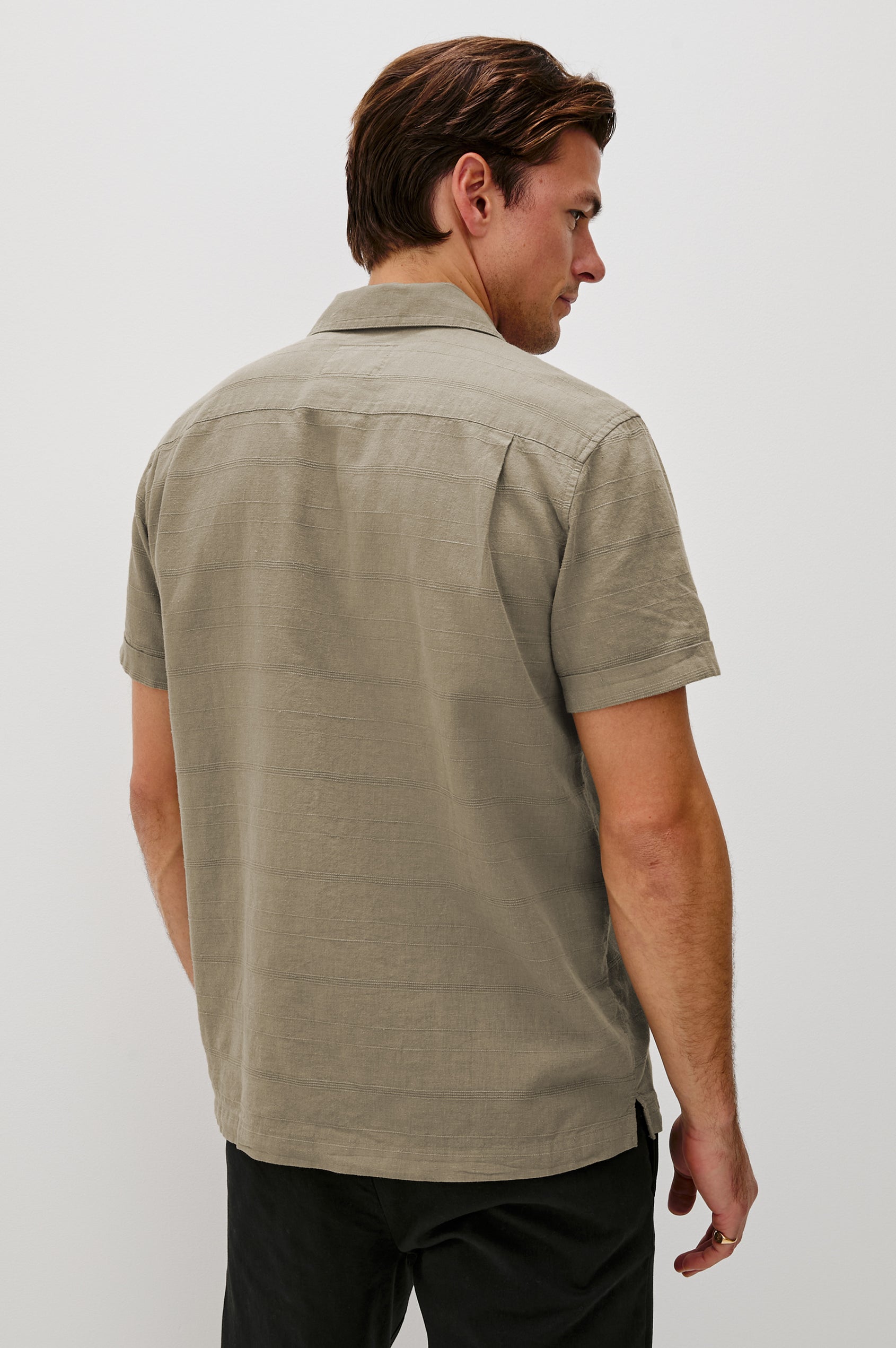 Davis Short Sleeve Button Up with a Chest Patch Pocket, Rolled Cuffs and Textured Horizontal Stripes in Crater Colorway - Back View Featured on Model