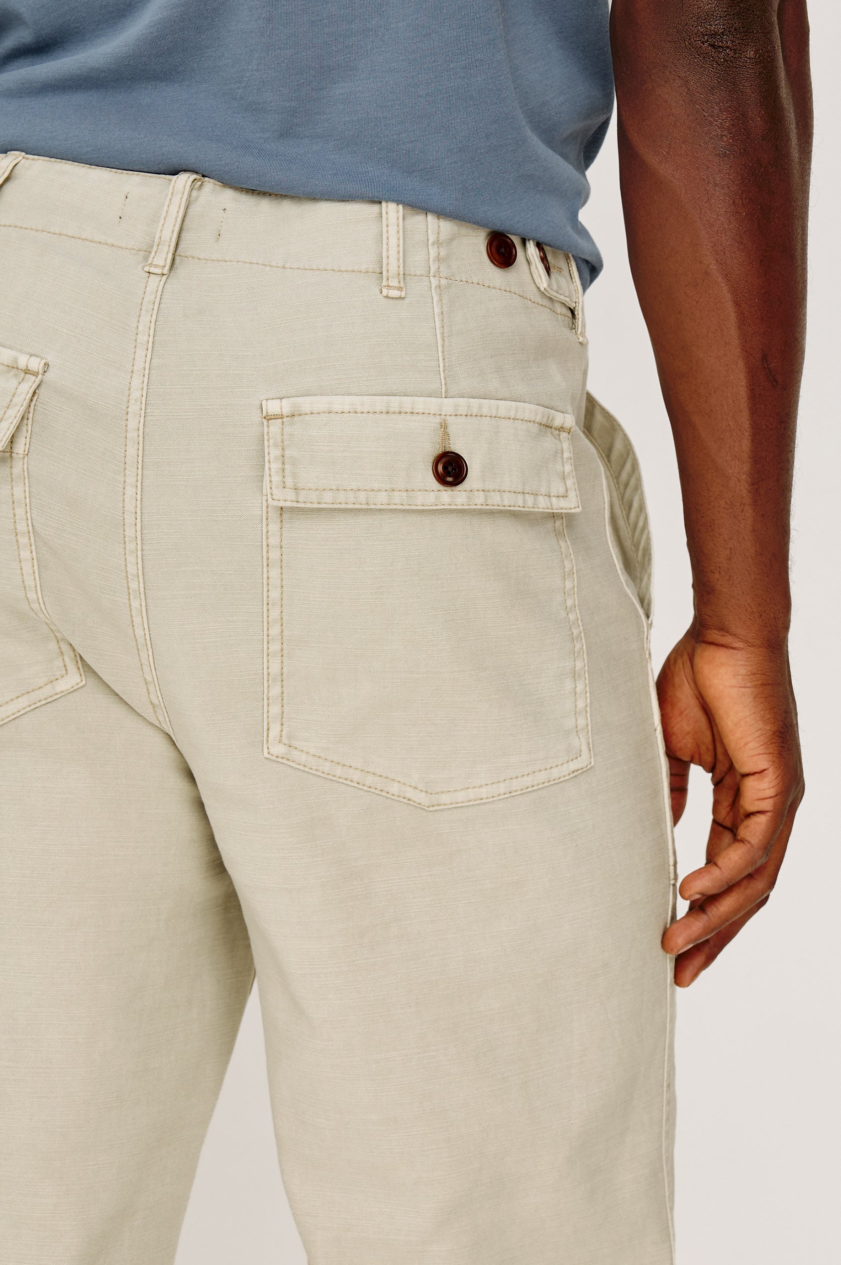 Decker Relaxed Straight Leg Workwear Pant in Stretch Cotton With Lived-In Wash, Zip Fly, and Side and Back Buttoned-Flap Pockets in Natural Colorway - Lower Body Back Detail View Featured on Model