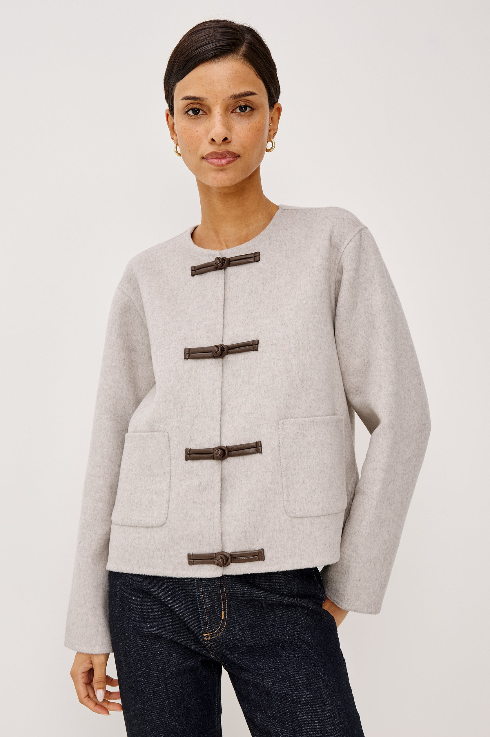 Deidre Jacket in Soft Wool Blend With Collarless Neckline, Boxy Cropped Fit, Front Leather Toggle Closures, Patch Pockets, and Long Sleeves in Heather Oat Colorway - Upper Body Front View Featured on Model