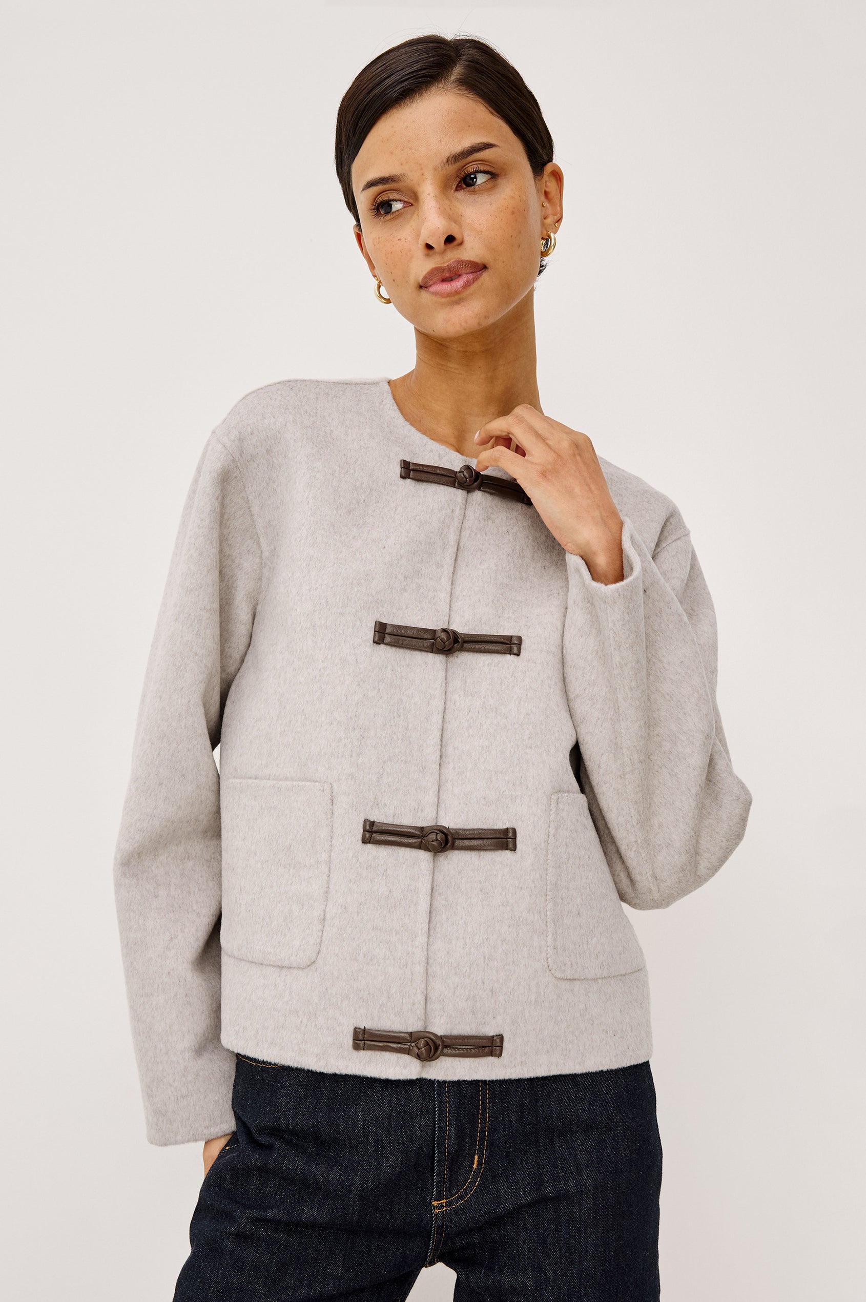 Deidre Jacket in Soft Wool Blend With Collarless Neckline, Boxy Cropped Fit, Front Leather Toggle Closures, Patch Pockets, and Long Sleeves in Heather Oat Colorway - Upper Body Front View Featured on Model