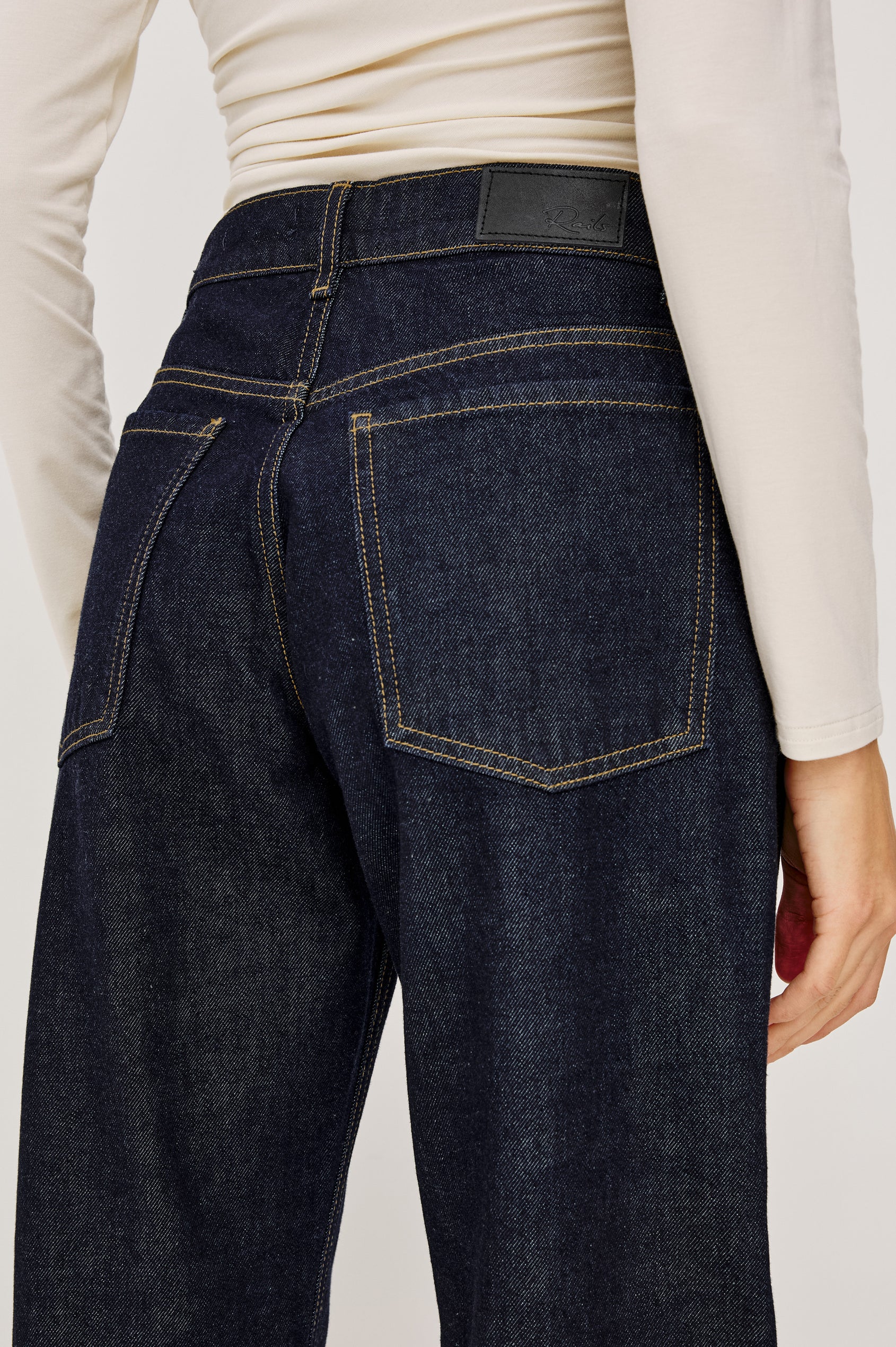 Del Mar Low-Rise Wide Straight Leg Jean in Rigid Dark Wash Denim With Wide Straight Legs, Saddle Seam Detailing, in Onyx Colorway - Lower Body Back Close Up View Featured on Model