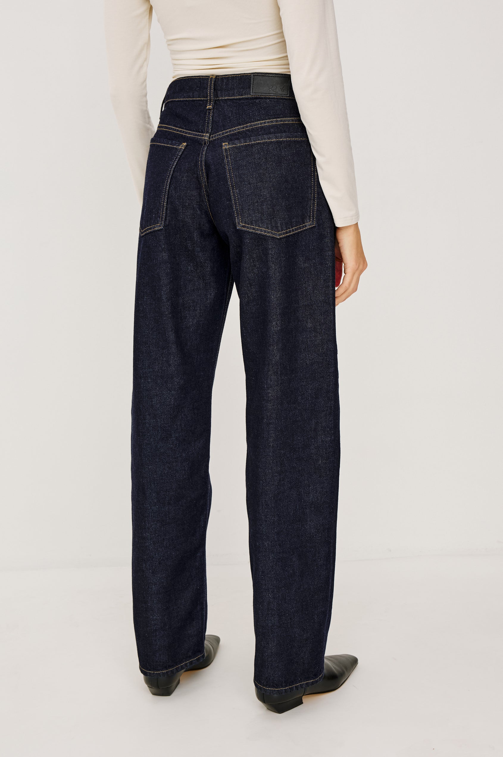 Del Mar Low-Rise Wide Straight Leg Jean in Rigid Dark Wash Denim With Saddle Seam Detailing, 5-Pockets, and Belt Loops in Onyx Colorway - Lower Body Back View Featured on Model