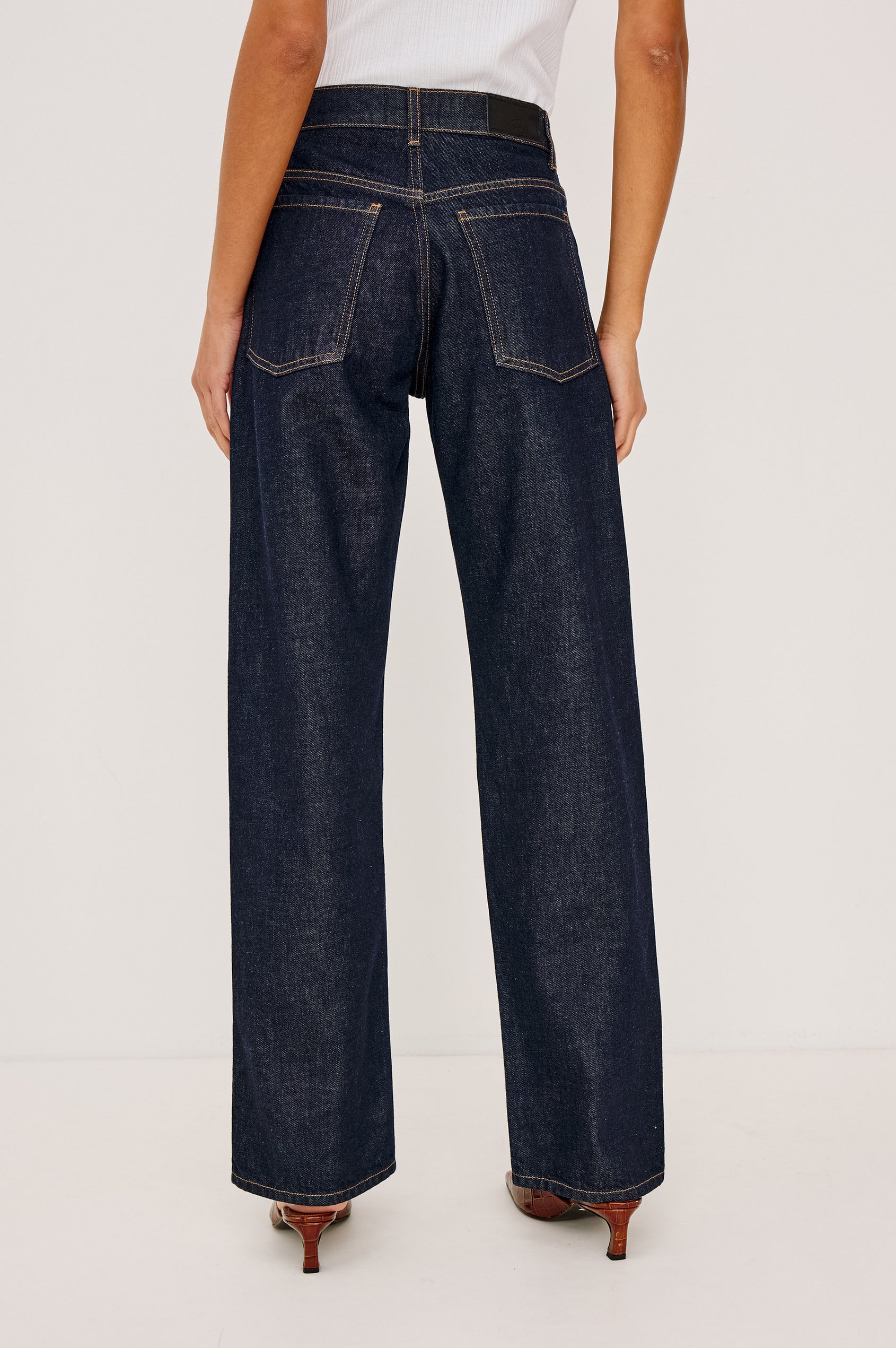 Del Mar Low-Rise Wide Straight Leg Jean in Rigid Dark Wash Denim With Wide Straight Legs, Saddle Seam Detailing, in Onyx Colorway - Lower Body Front View Featured on Model