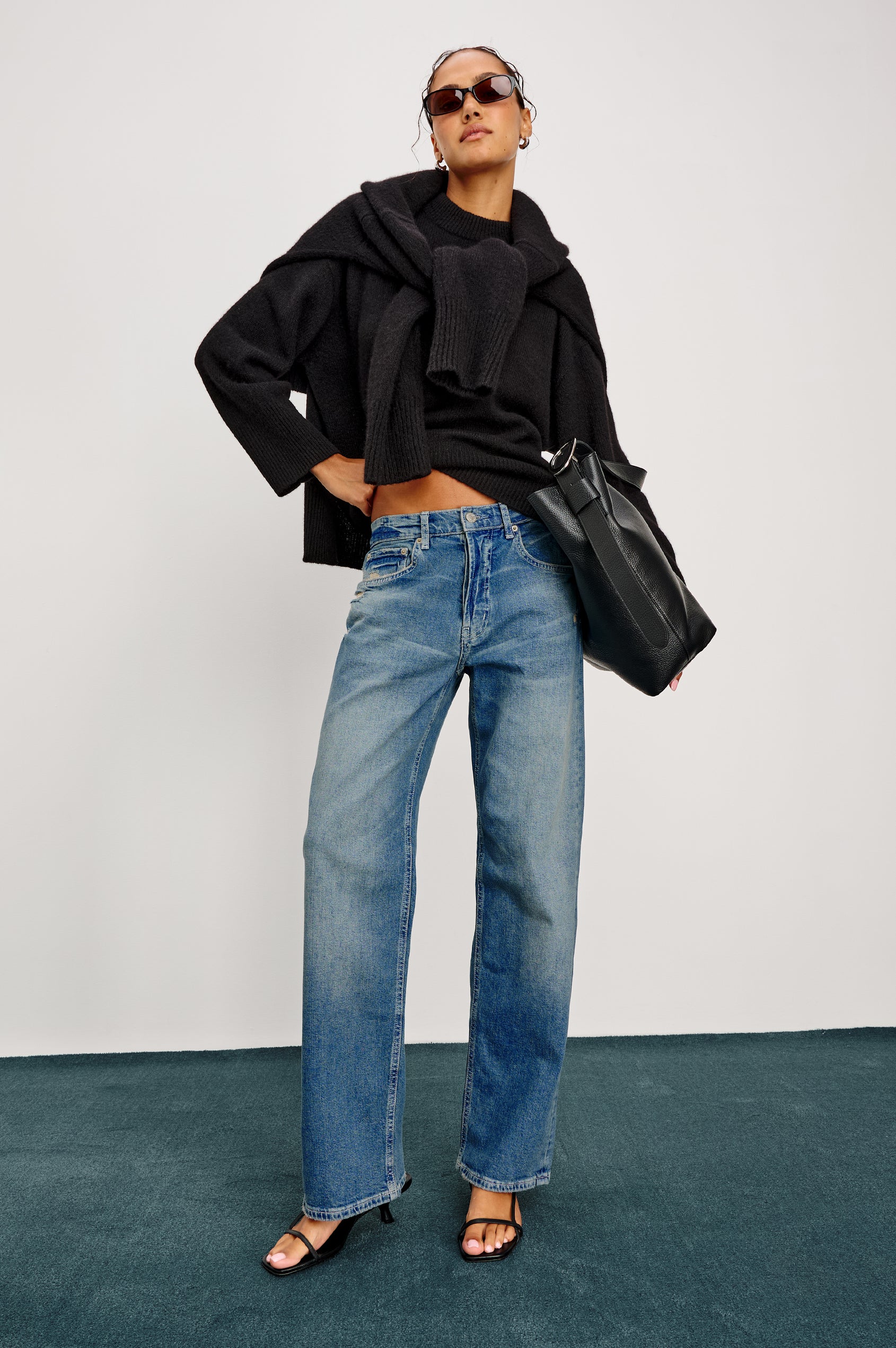 Del Mar low slung baggy boyfriend 5-pocket jean in medium wash Tinted Indigo Destroy, with light destruction near front pockets - front full body view featured on model.