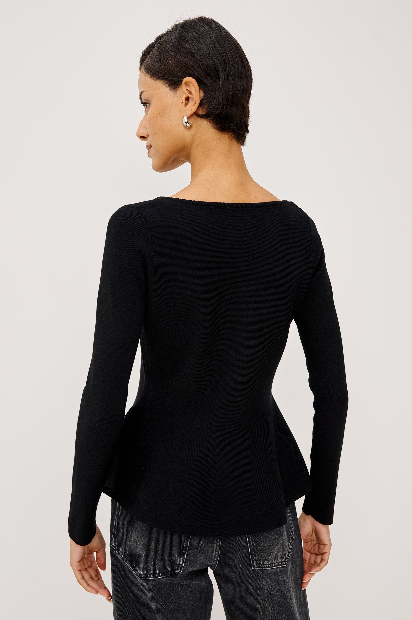 Diane Cardigan in Fine-Gauge Knit With Fitted Body, Peplum Hem, Round Neckline, and Center Front Placket With Self-Covered Buttons in Black Colorway - Upper Body Back View Featured on Model