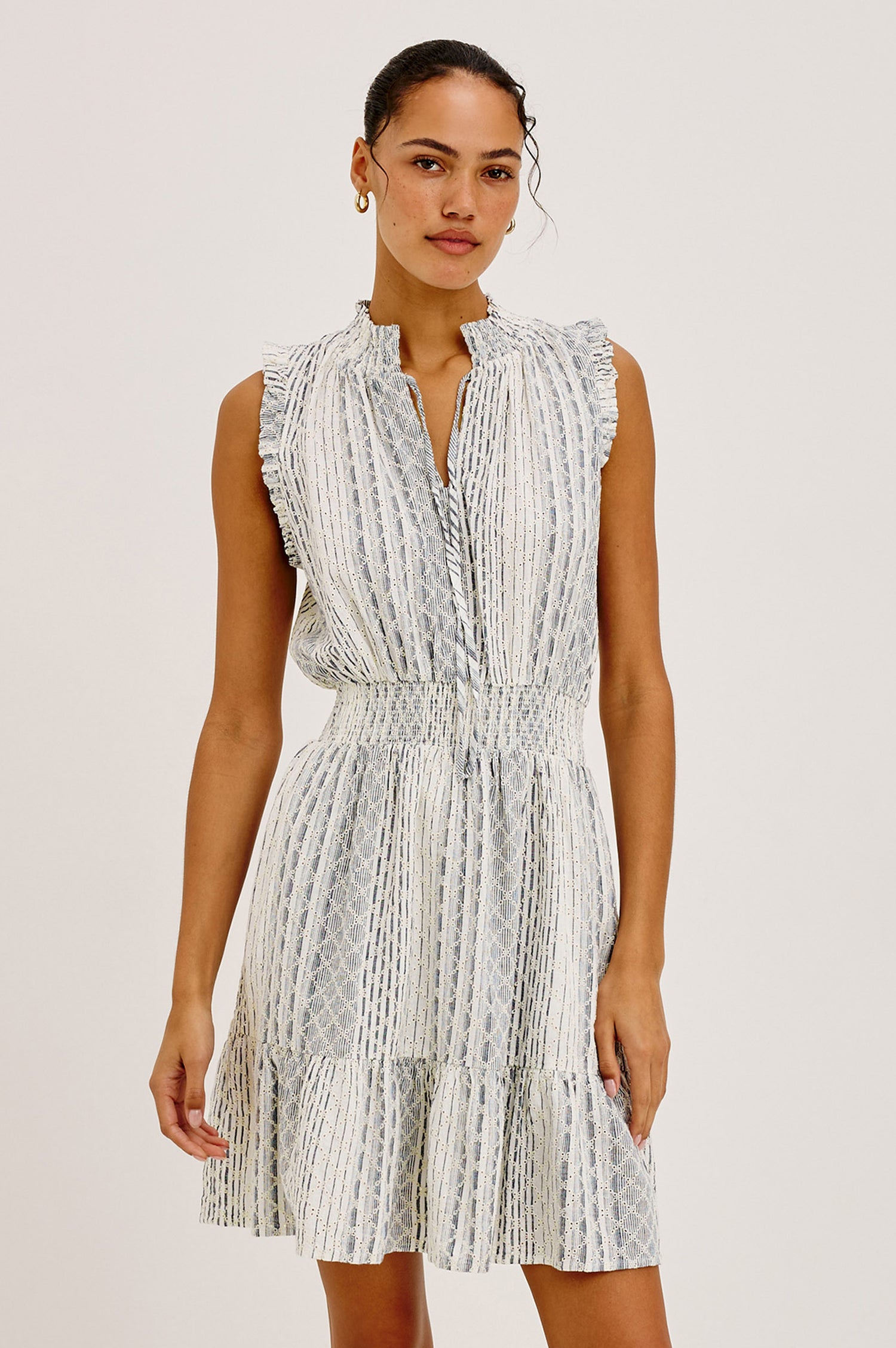 Didi Peasant Style Mini Dress in Luxe Linen With Front Button Placket, Smocked Waist, and Tiered Hem in Striped Eyelet Colorway - Upper Body Front View Featured on Model
