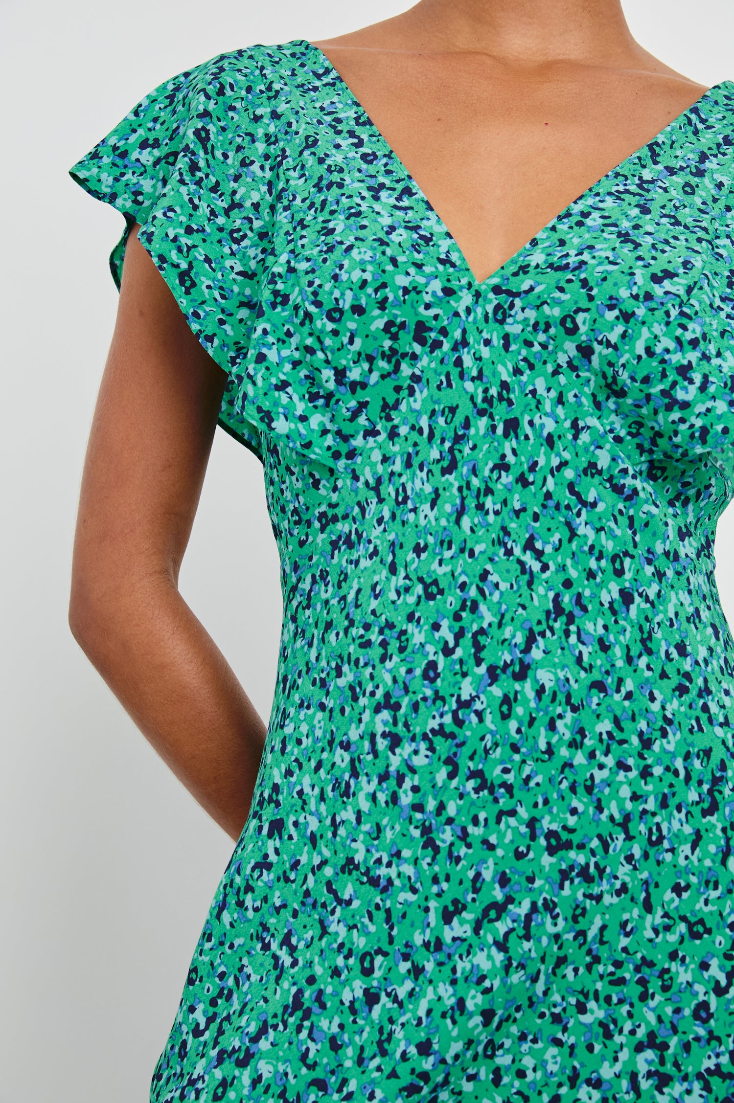Dina Short-Sleeve Midi Dress with a Deep V Neck, Flutter Sleeves, and a Thigh Side Slit in Green Speckled Colorway, speckles in Green, Blues and Black - Front View Featured on Model