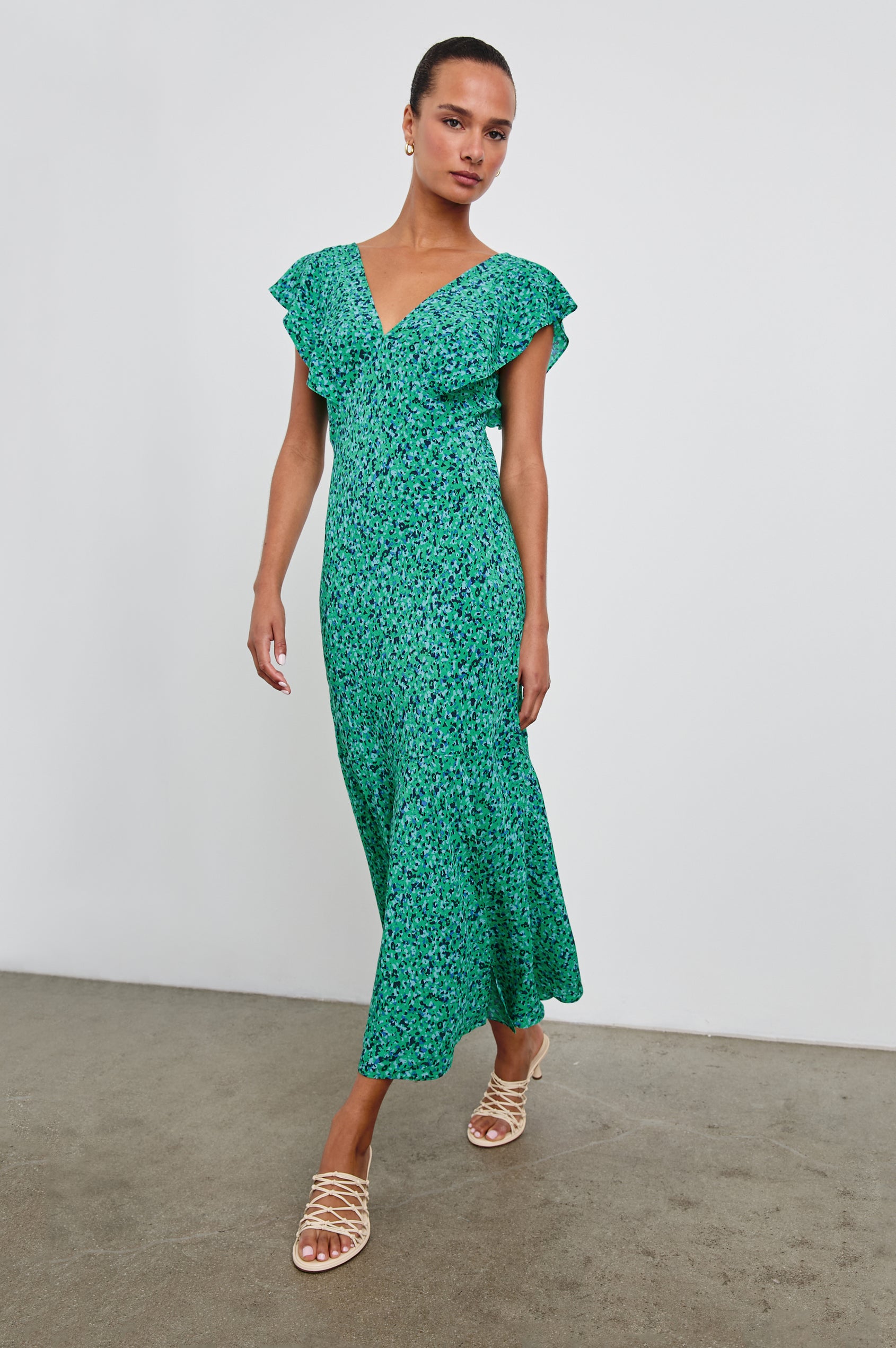 Dina Short-Sleeve Midi Dress with a Deep V Neck, Flutter Sleeves, and a Thigh Side Slit in Green Speckled Colorway, speckles in Green, Blues and Black - Front Full Body View Featured on Model