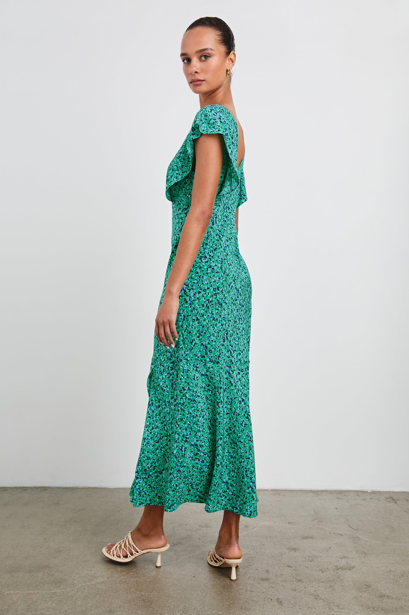 Dina Short-Sleeve Midi Dress with a Deep V Neck, Flutter Sleeves, and a Thigh Side Slit in Green Speckled Colorway, speckles in Green, Blues and Black - Side Full Body View Featured on Model