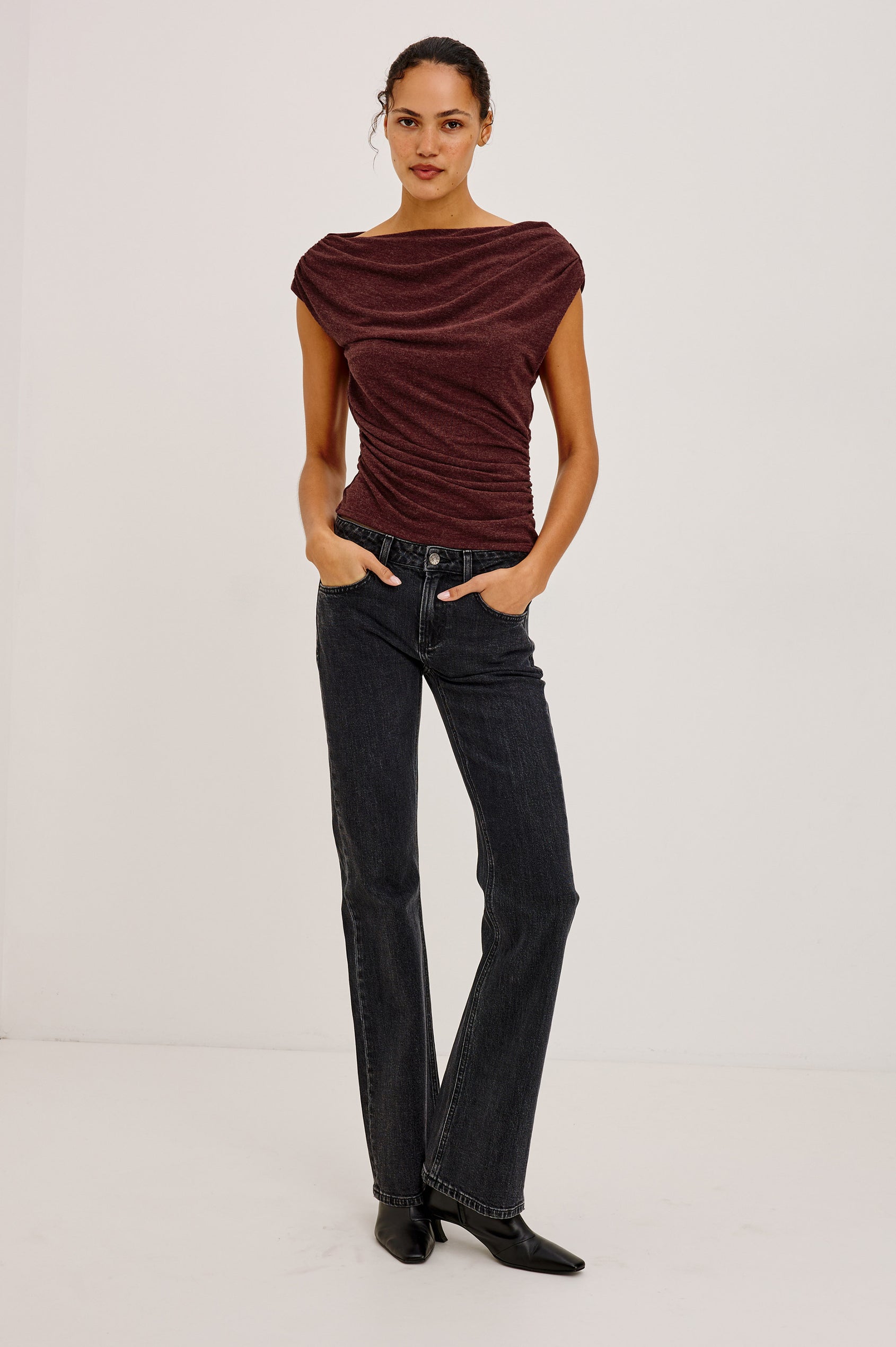 Dominic Top in Soft Jersey With Off-The-Shoulder One-Shoulder Design, Shirred Shoulders, and Ruched Waist in Merlot Colorway - Full Body Front View Featured on Model