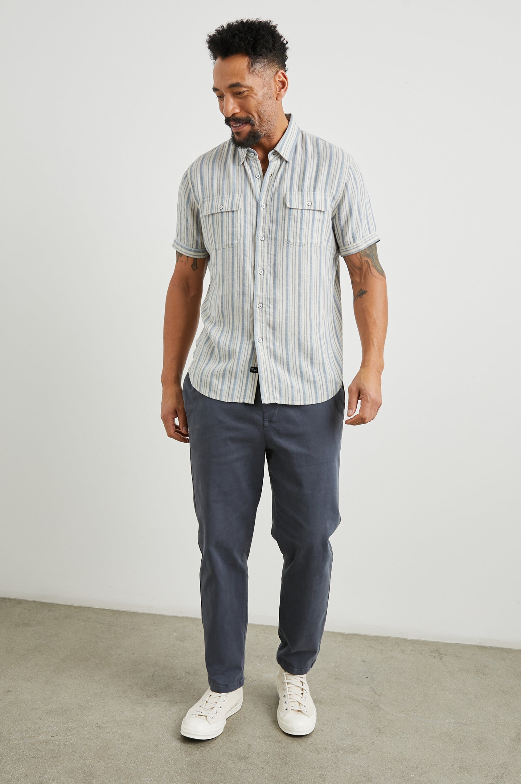 Donnie Short-Sleeve Button Up with Two Chest Button Flap Pockets in Blue Cap Range Colorway, Vertical Stripes in Muted Blues and Cream - Front Full Body View Featured on Model