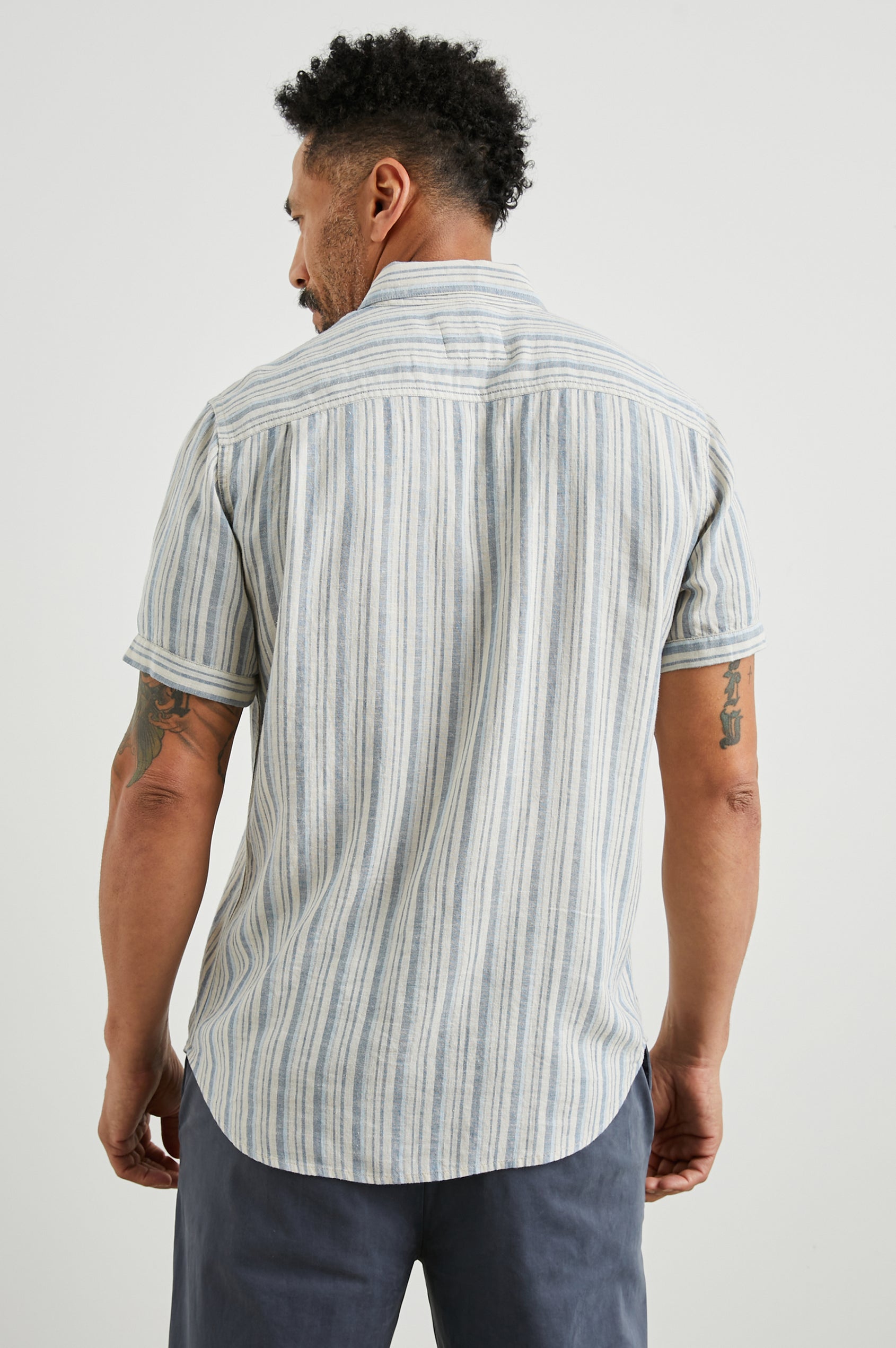 Donnie Short-Sleeve Button Up with Two Chest Button Flap Pockets in Blue Cap Range Colorway, Vertical Stripes in Muted Blues and Cream - Back View Featured on Model