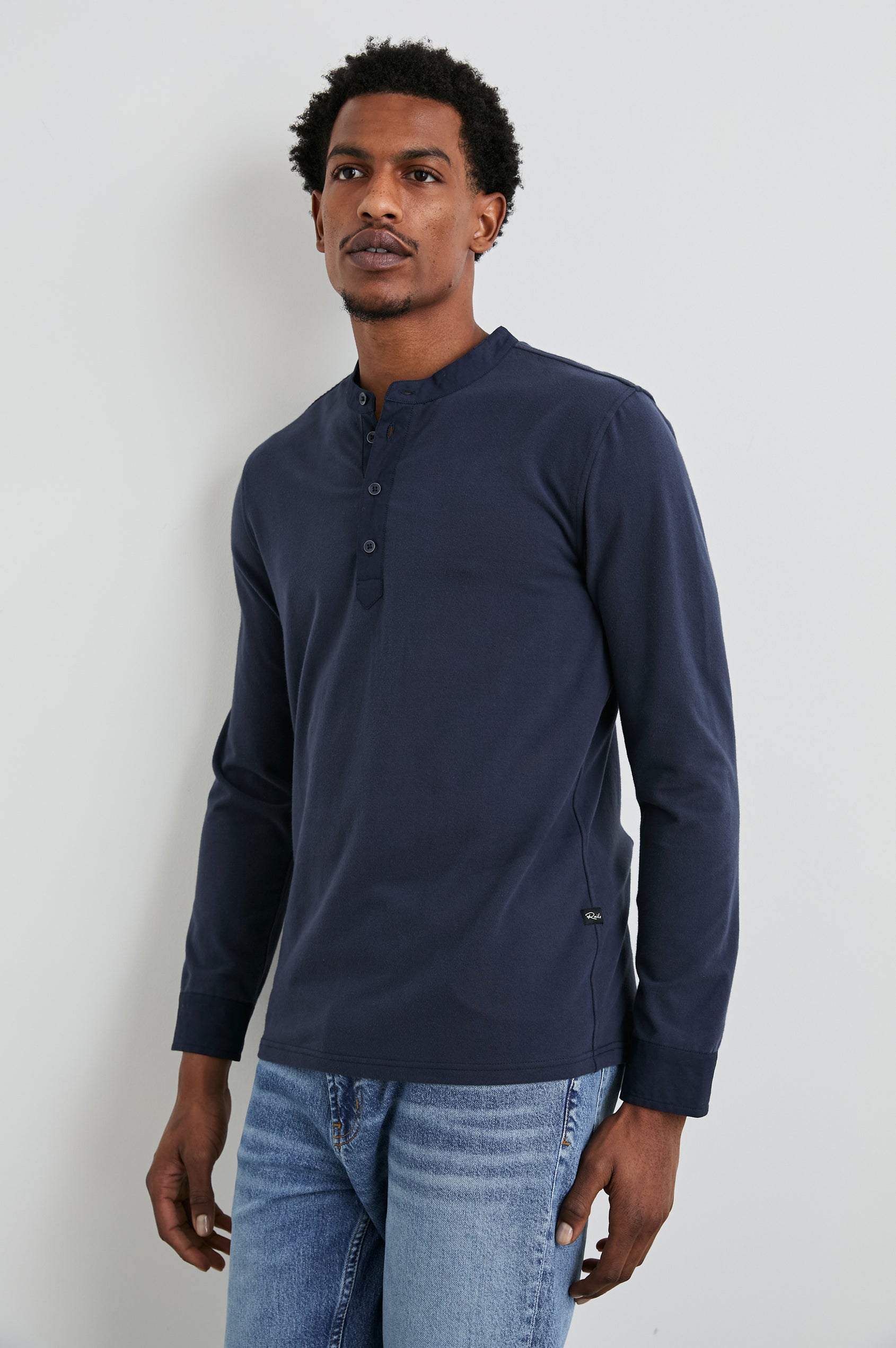 Dremond Long Sleeve Shirt with a Three Button Placket and Buttoned Cuffs in Perfect Navy Colorway - Front View Featured on Model