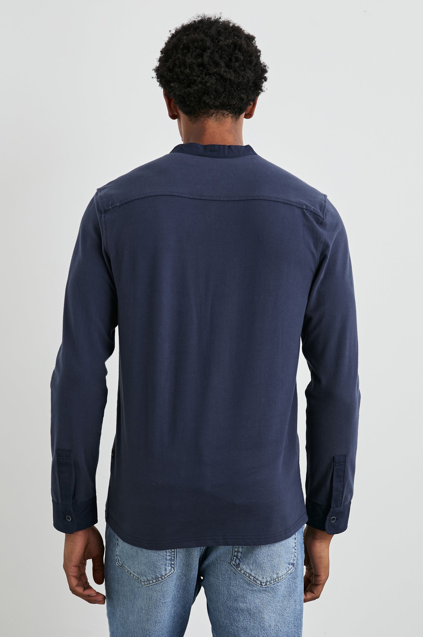 Dremond Long Sleeve Shirt with a Three Button Placket and Buttoned Cuffs in Perfect Navy Colorway - Back View Featured on Model