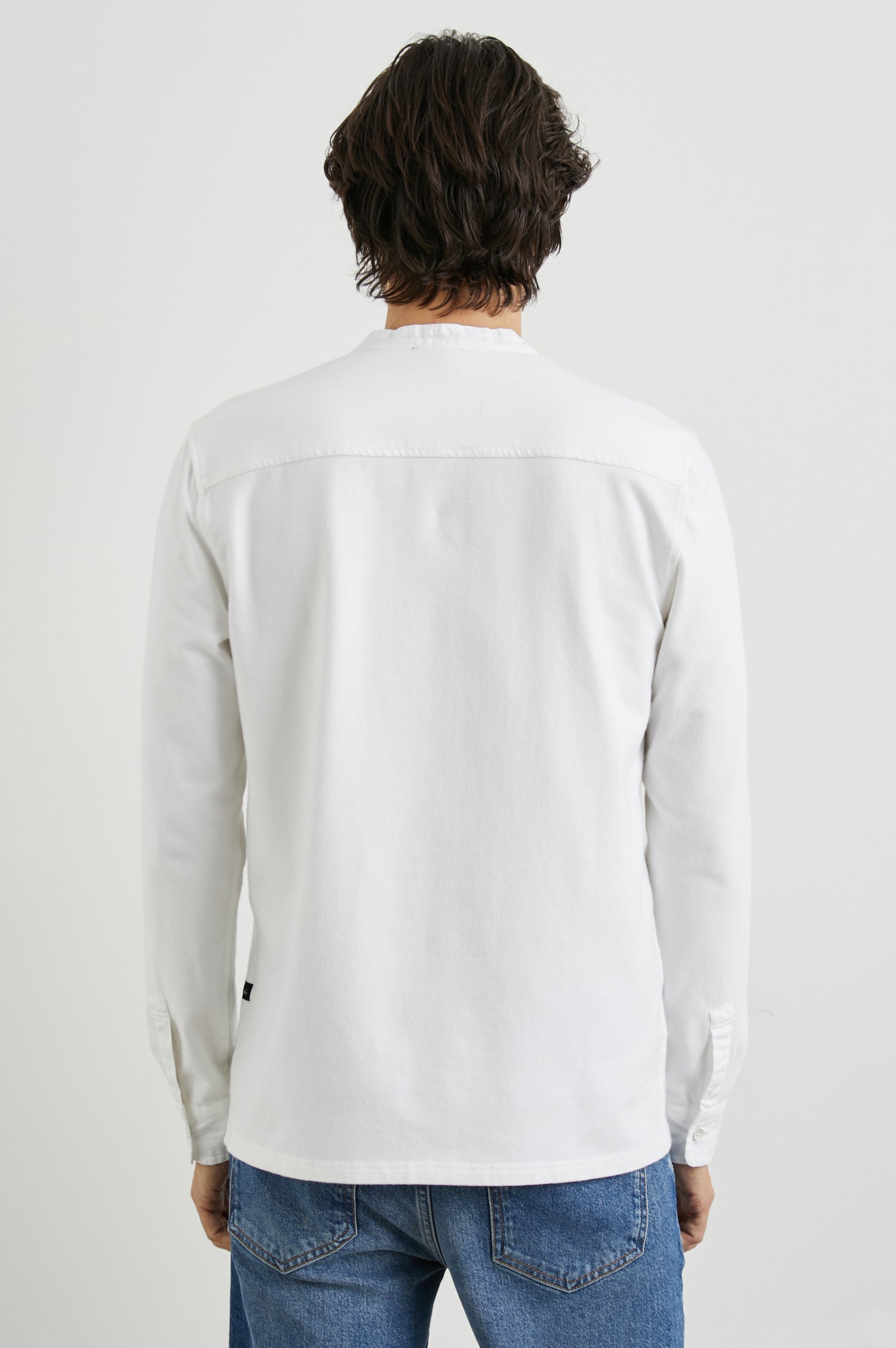 Dremond Long Sleeve Shirt with a Three Button Placket and Buttoned Cuffs in White Colorway - Back View Featured on Model