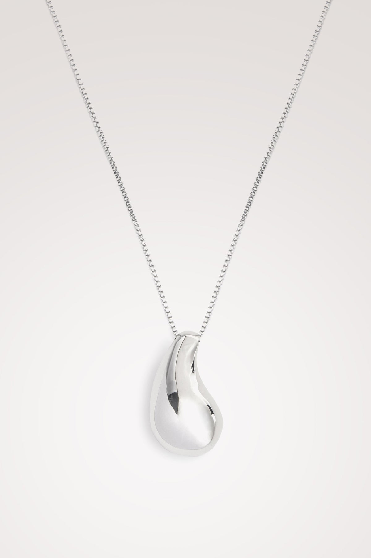 Drop Pendant Necklace With Substantial Organic-Shaped Pendant, Box Chain, and Lobster Clasp Closure in Silver Colorway - Flat Lay Product Close Up View Featured