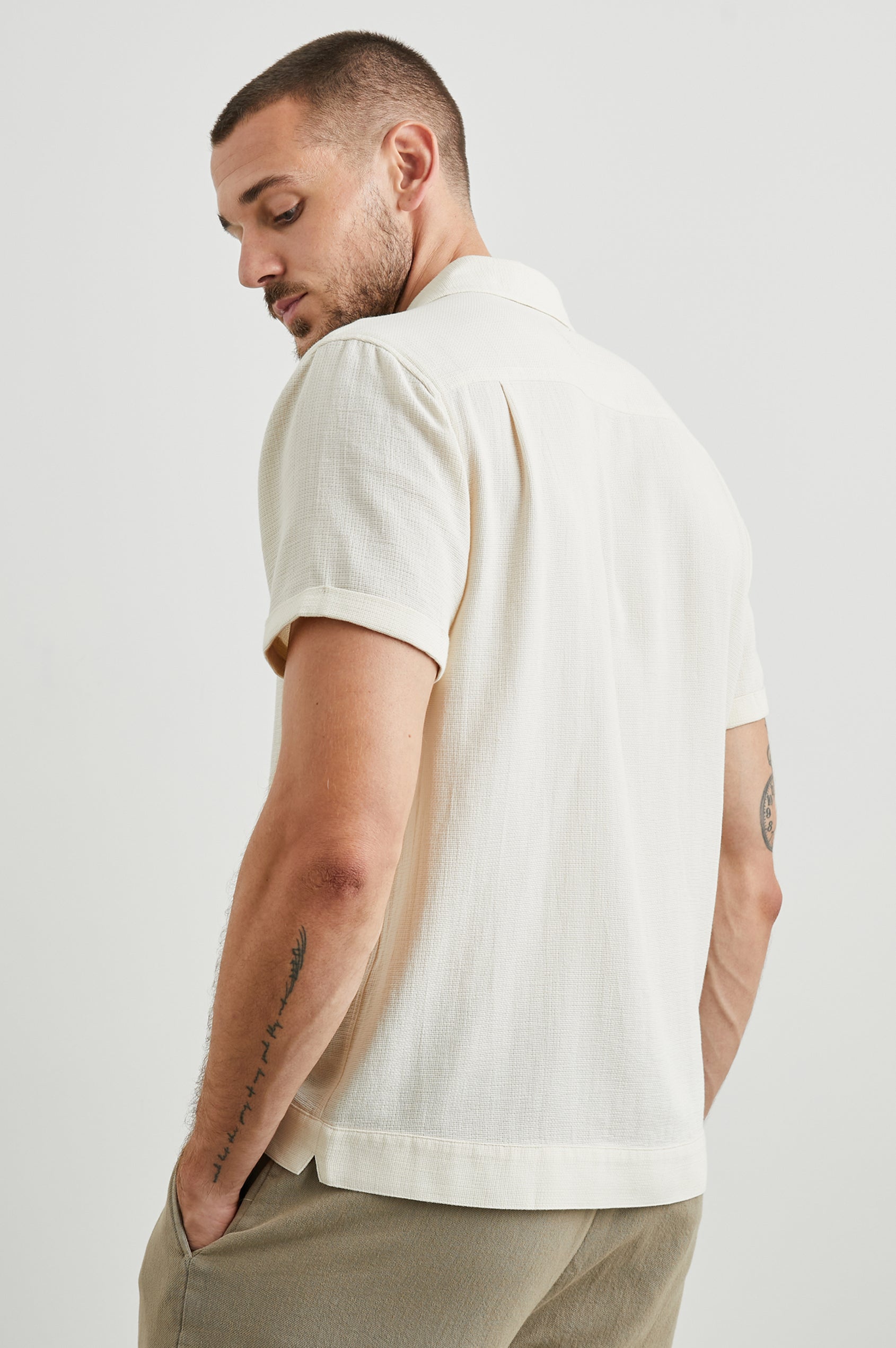 Duke Short Sleeve Button Up with Rolled Cuffs and in Parchment Wheat Colorway, Alternating Vertical Panels of Wheat and Parchment - Side View Featured on Model