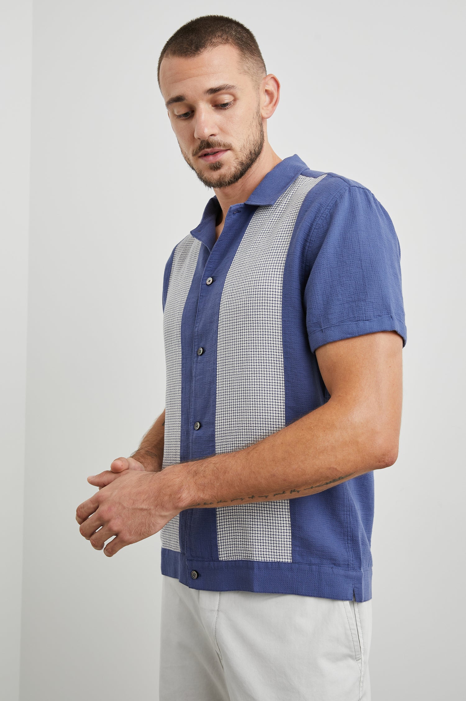 Duke Short Sleeve Button Up with Rolled Cuffs and in Royal Parchment Colorway, Alternating Vertical Panels of Blue and Parchment - Side View Featured on Model
