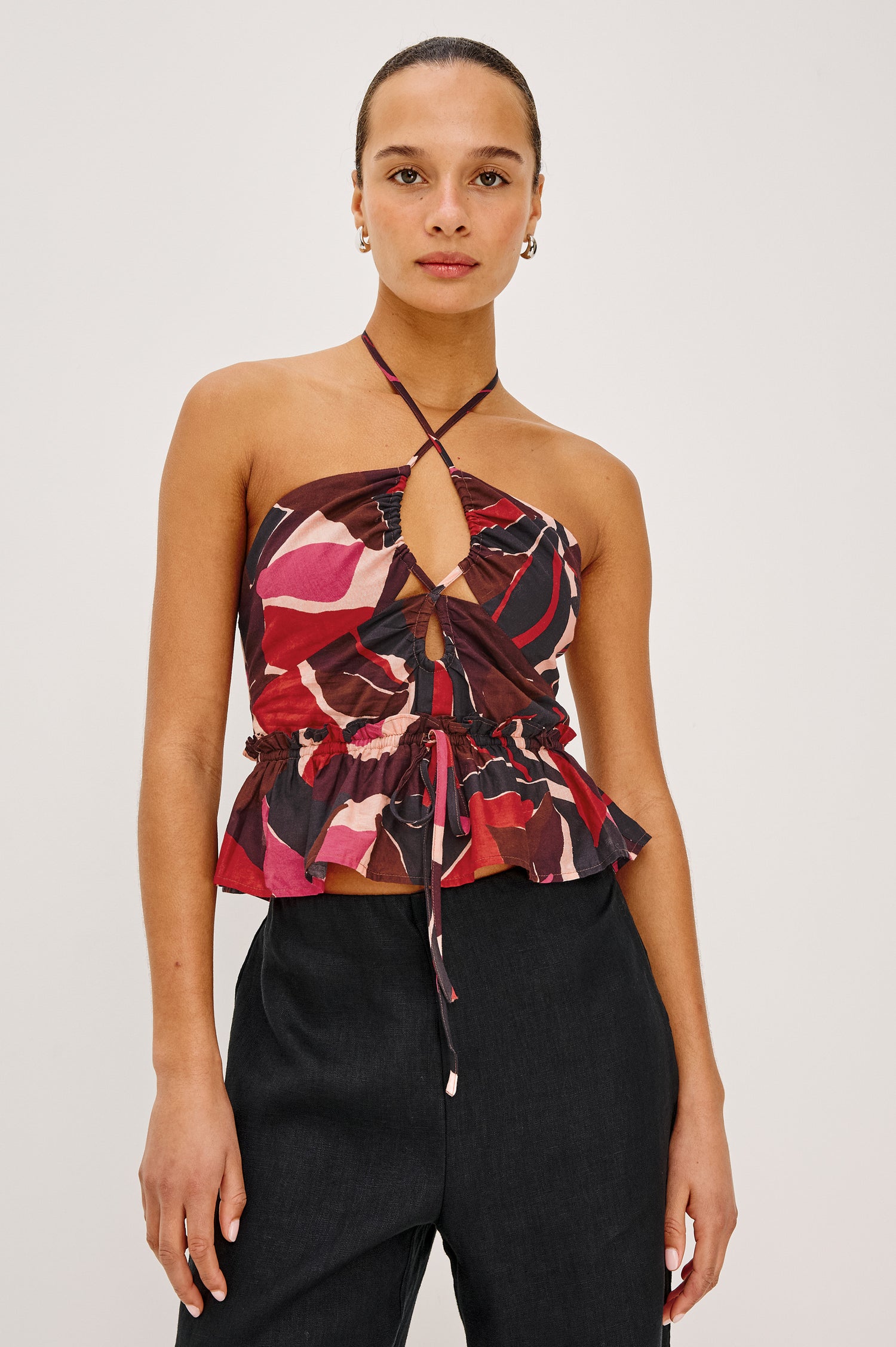 Dulce Cropped Tank Top in Cotton Voile With Abstract Print, Adjustable Halter Ties With Beaded Tassels, Front Keyhole Cutouts, Ruffle Trim and Hem, and Adjustable Front Self-Ties in Paradise Colorway - Close Up Front View Featured on Model